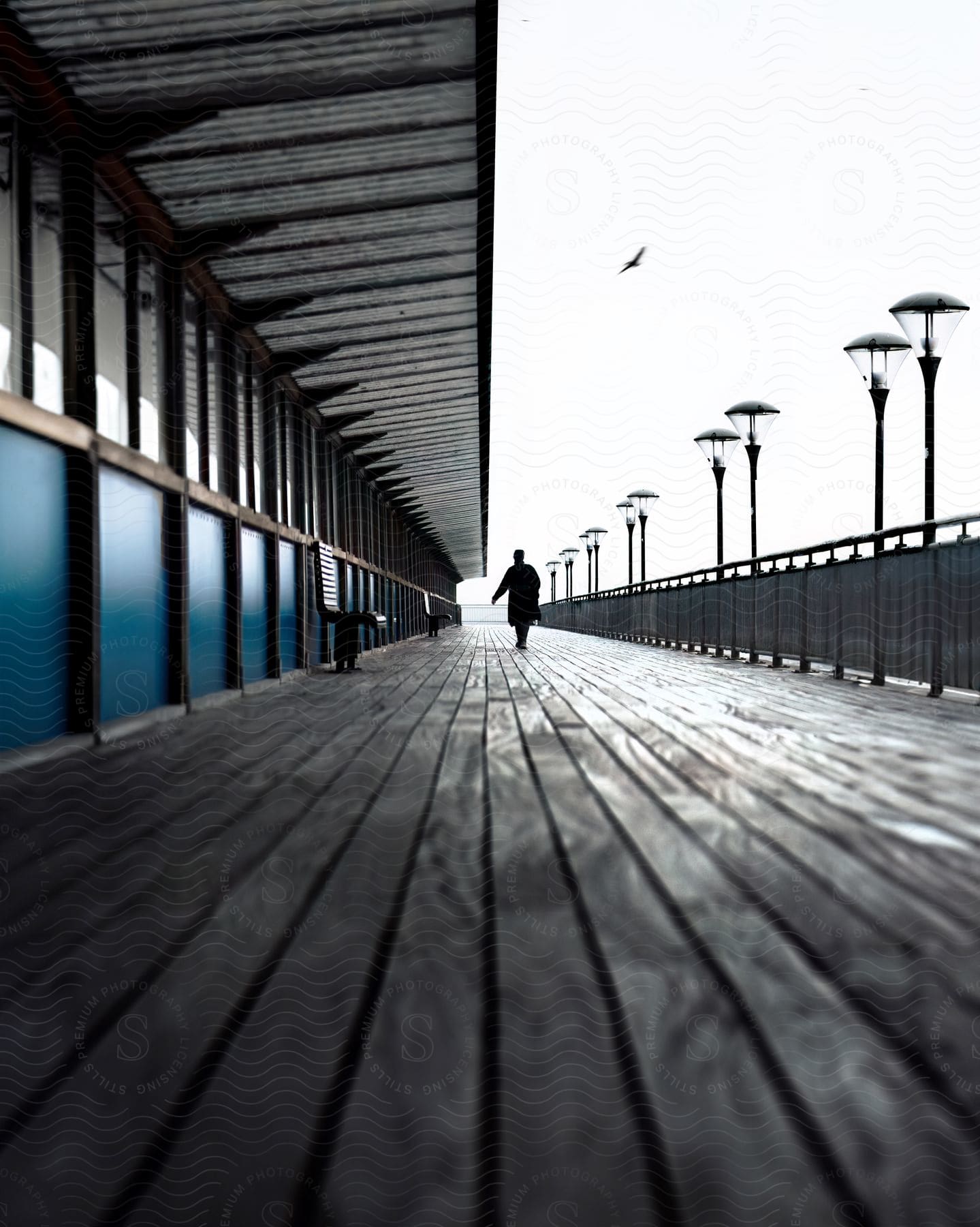 Silhouette of a person on a pier