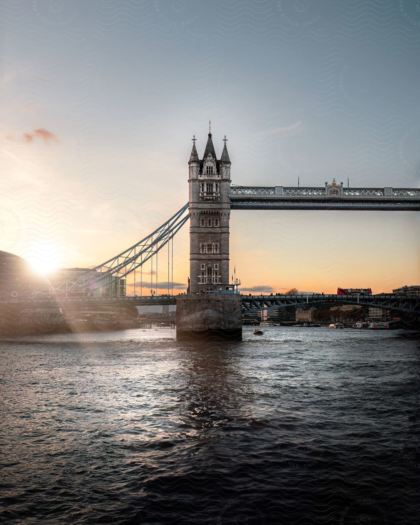 The sun rises on London Bridge over the river Thames.