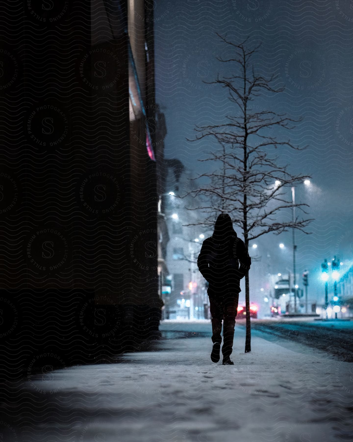 A man walking down a snowy street.