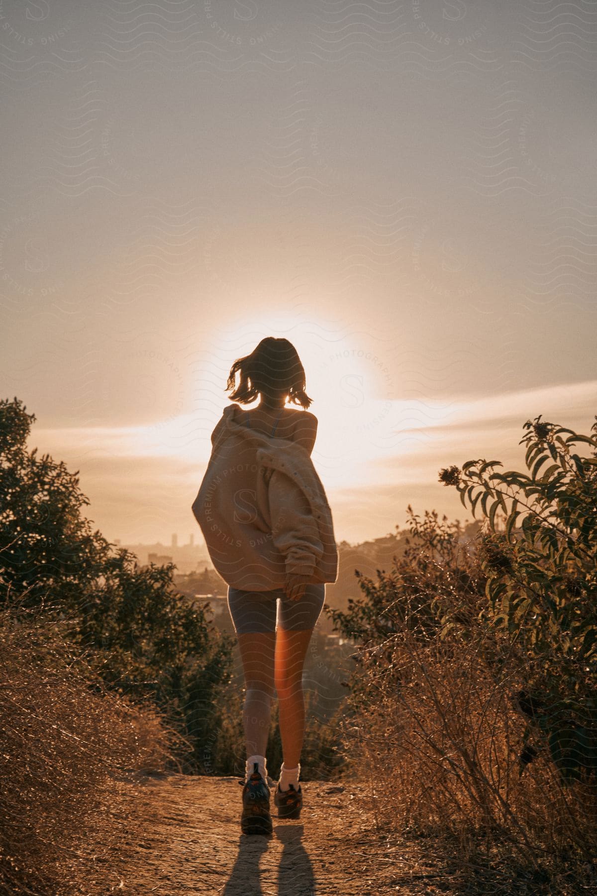 A girl running along a dirt track.