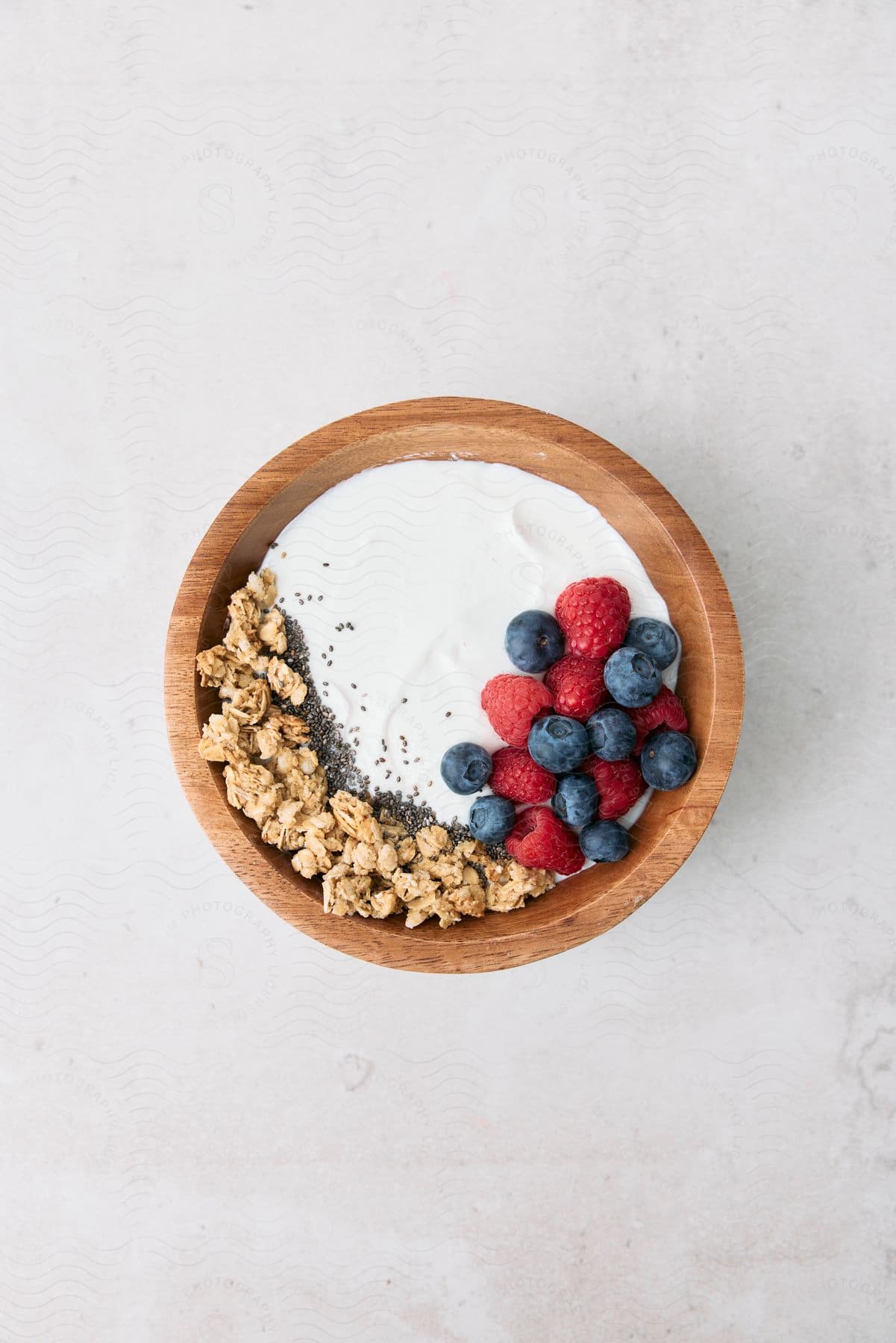 Cereal in a bowl with blueberries and raspberries