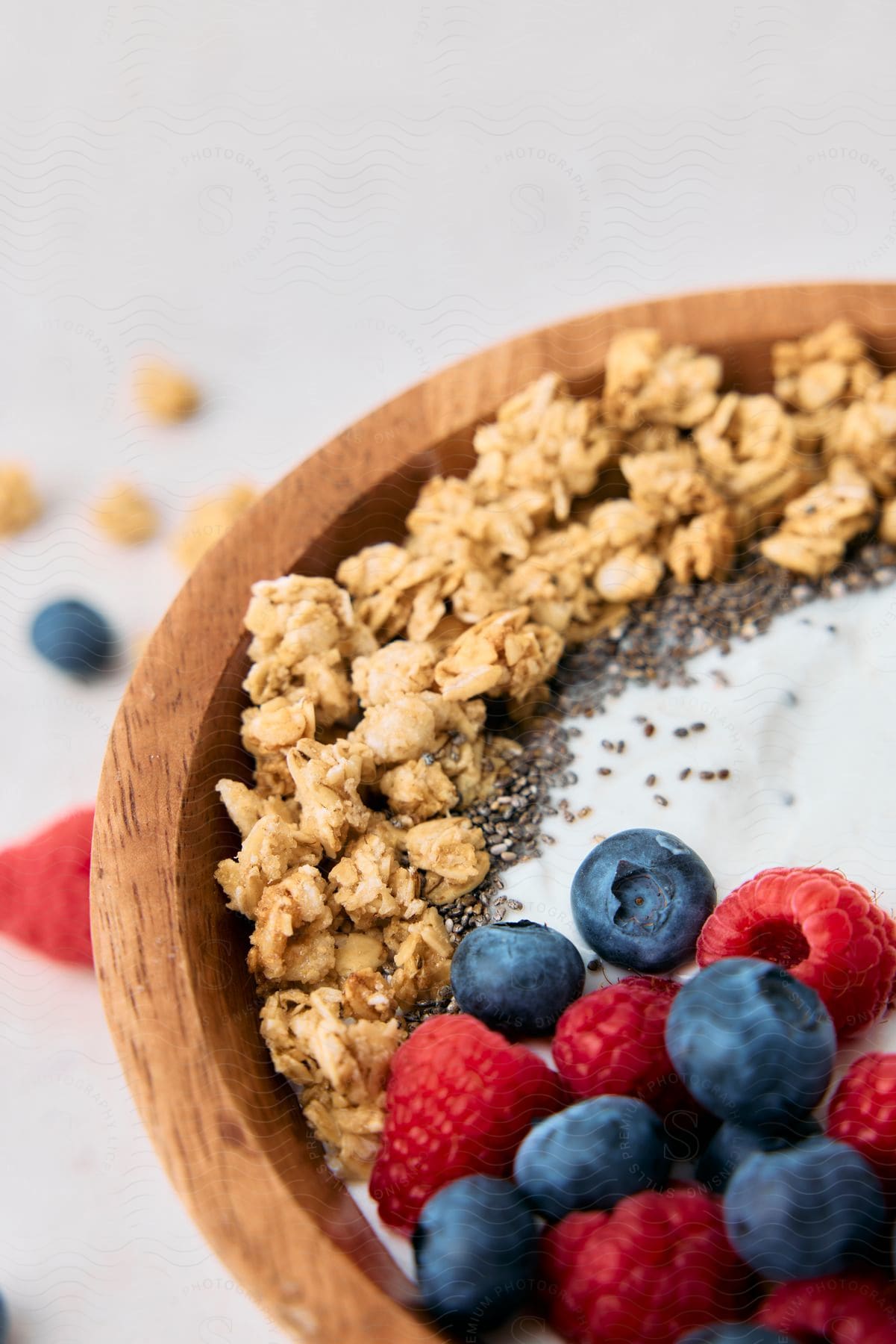 Close-up of a bowl of granola, yogurt and fresh berries.