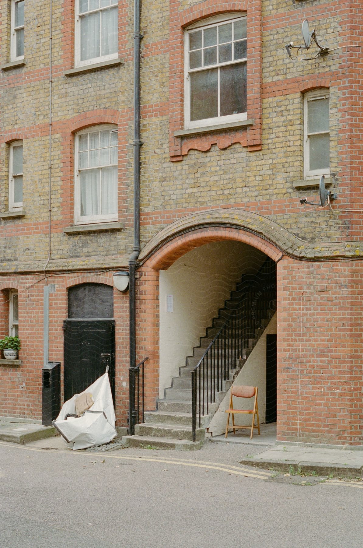 a red brick building with stairs leading up to it.