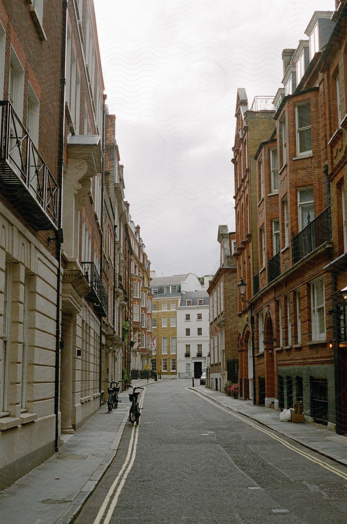 A narrow street lined with historic European residential buildings.