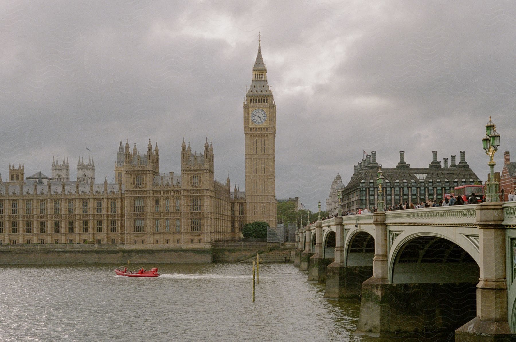 A view of Big Ben next to a bridge in London.