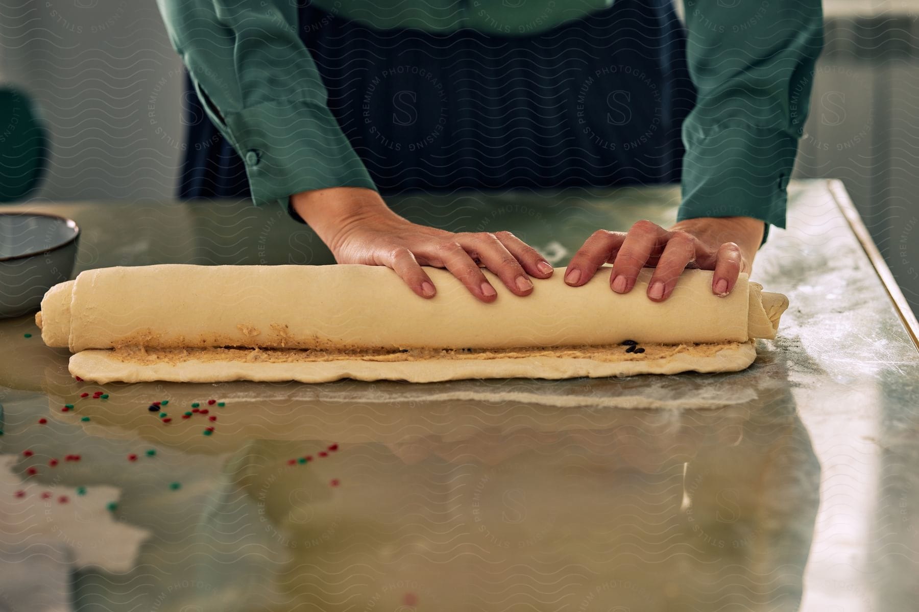 Stock photo of a chef is folding a dough preparing it for baking