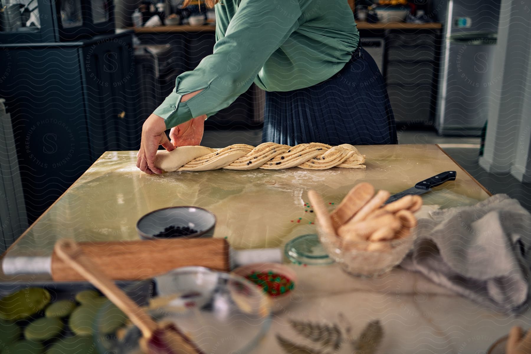 A woman baking bread in a kitchen in a house.