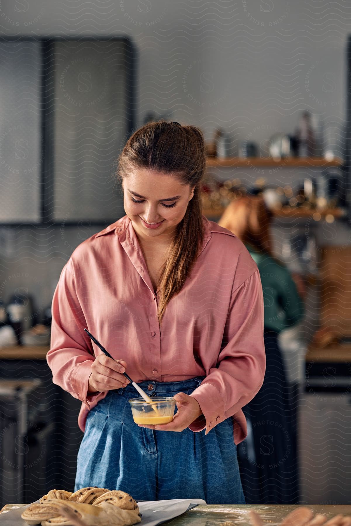 A woman baking food in a kitchen