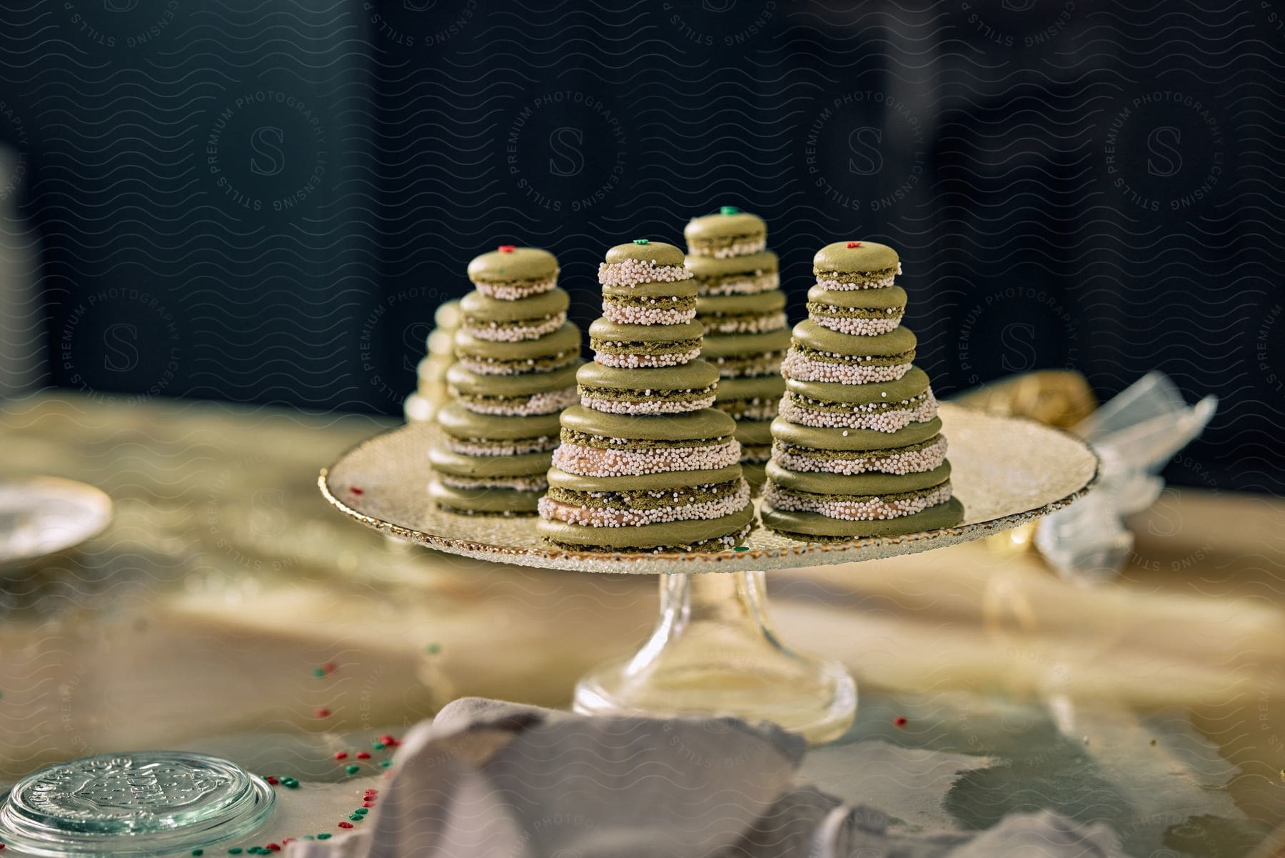 Green cookies stacked resembling Christmas trees an a serving dish.