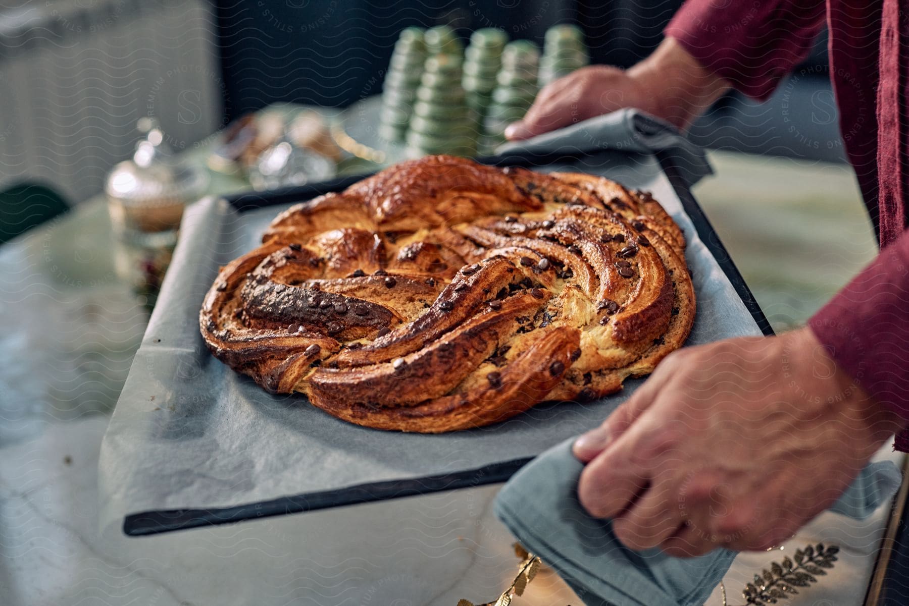 a person carrying a Salted Caramel Babka on a tray