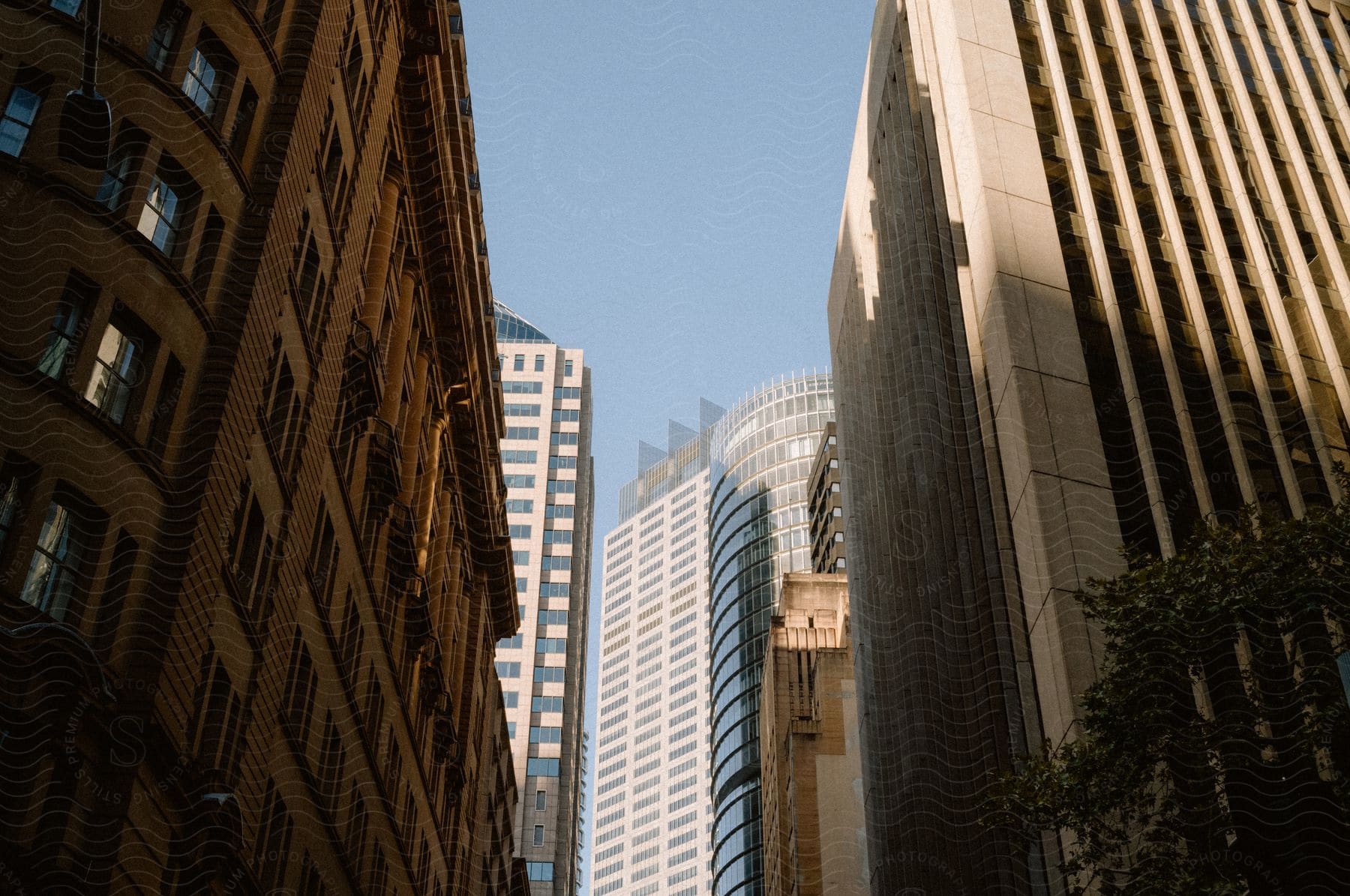 Several tall buildings in a city on a sunny day.