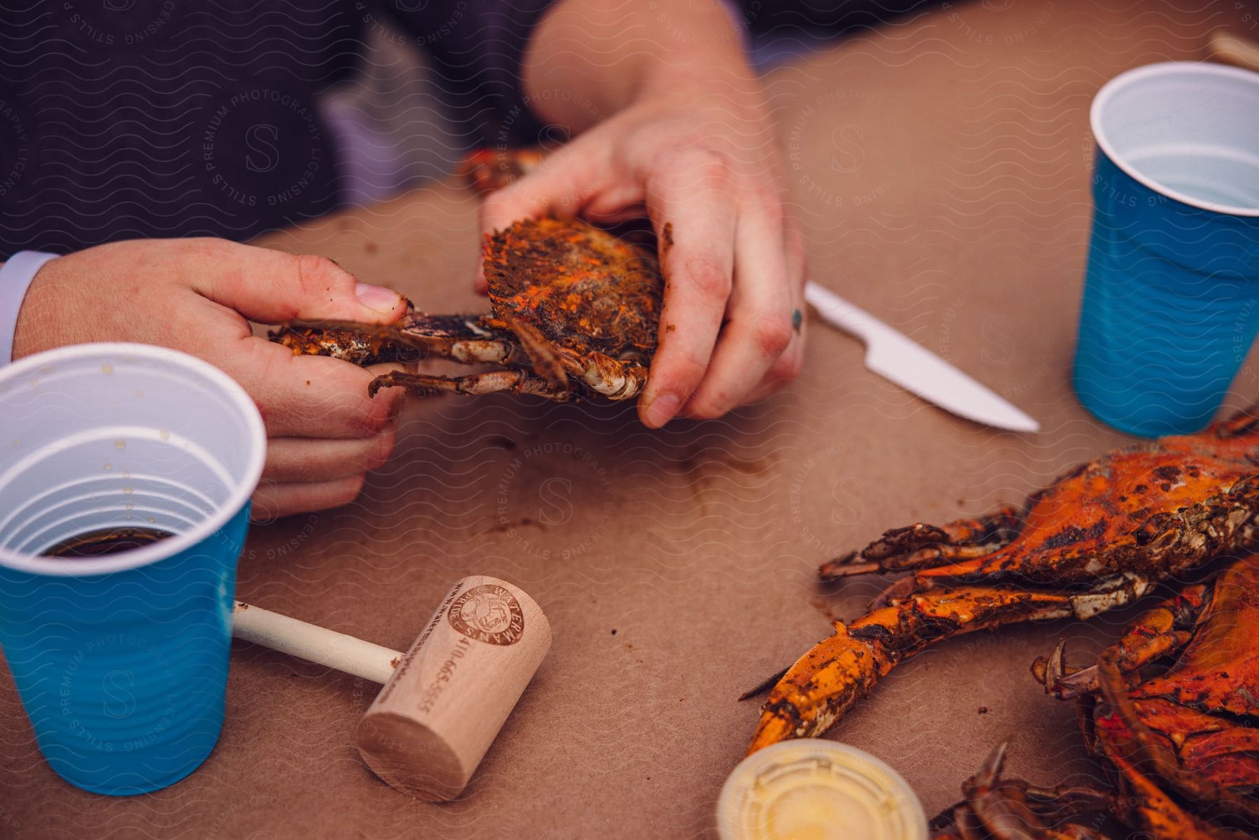 A man is sitting at a table eating a lobster