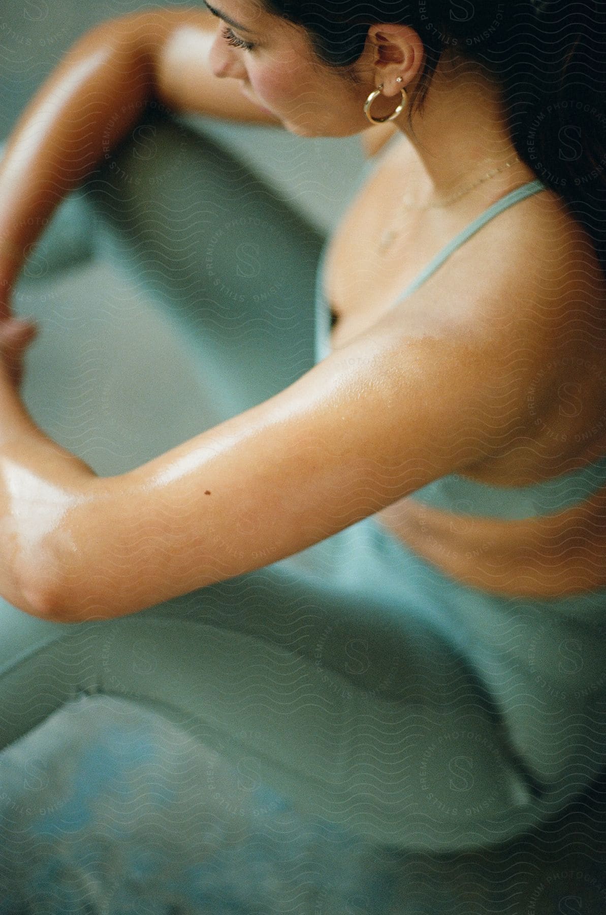 A Woman Is Sitting On The Floor Doing Stretching Exercises