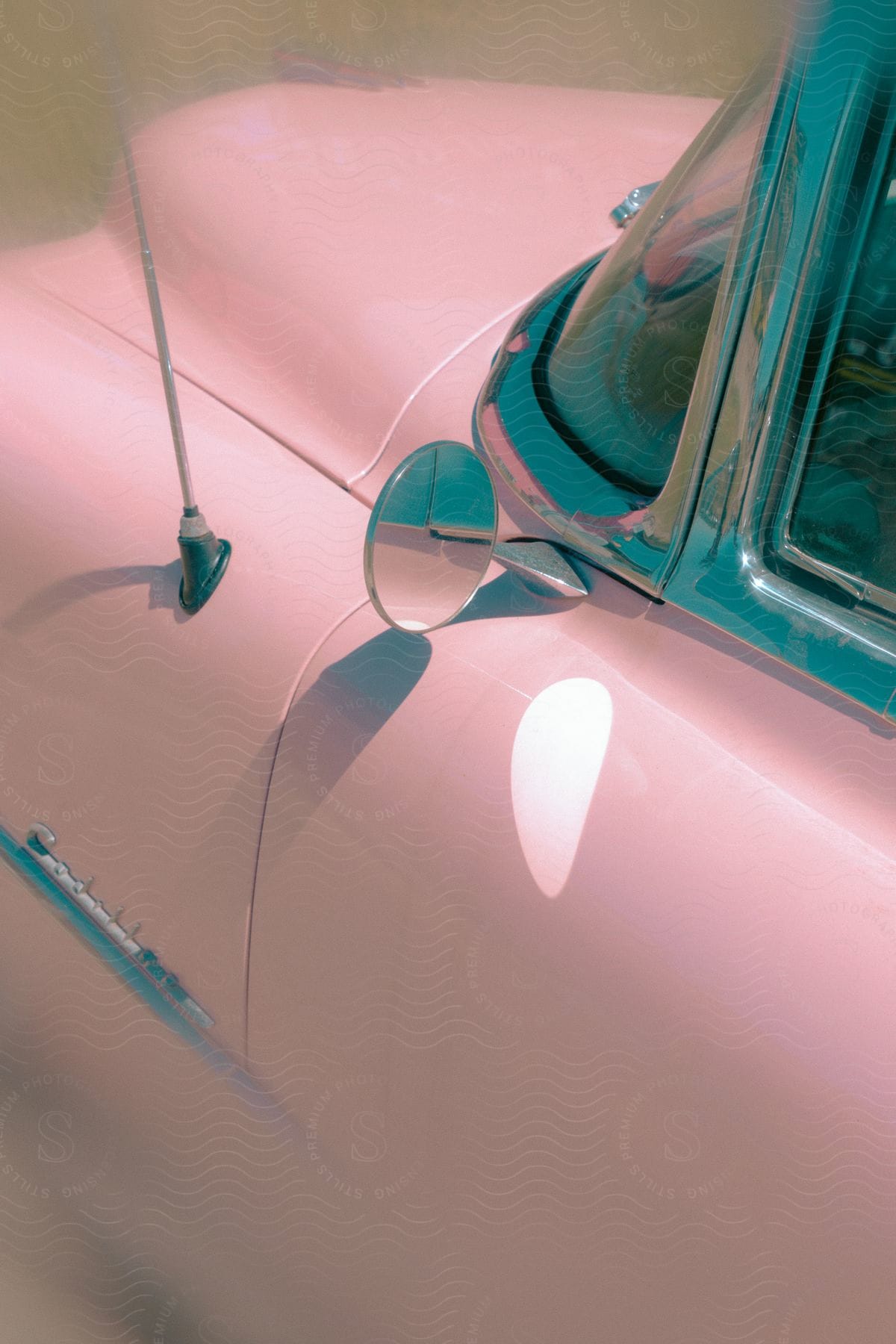 Rear view of an old pink car.