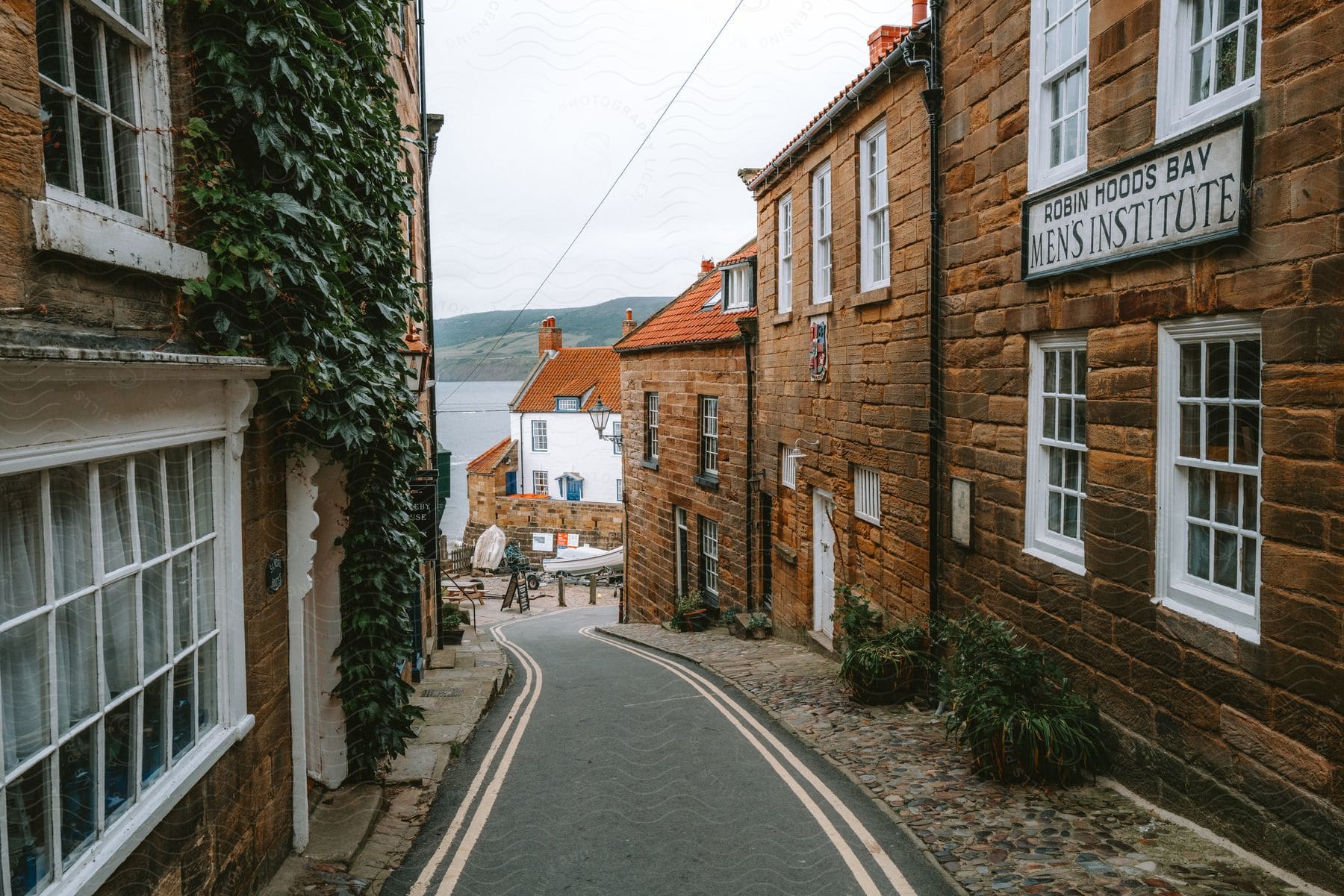 A narrow street running through an English coastal town.