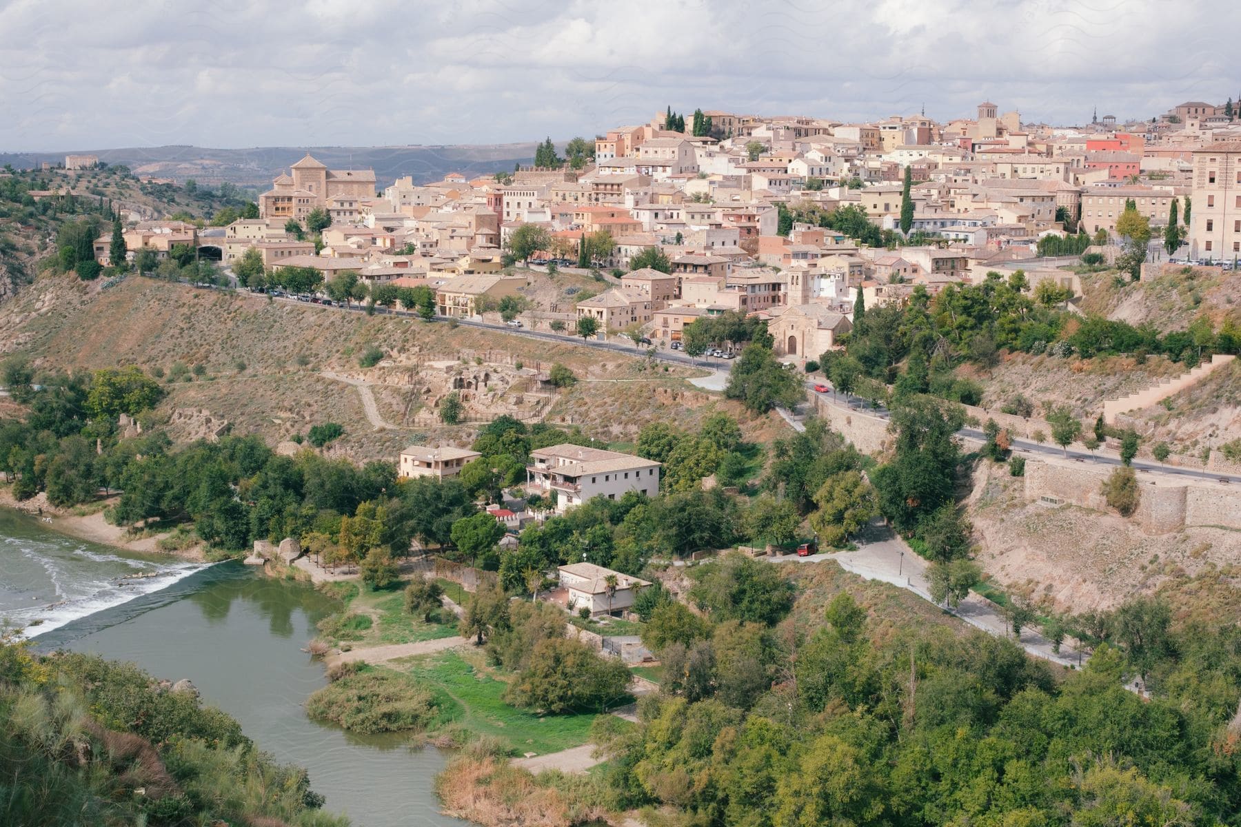 Panorama of an ancient walled city and the bank of a river.