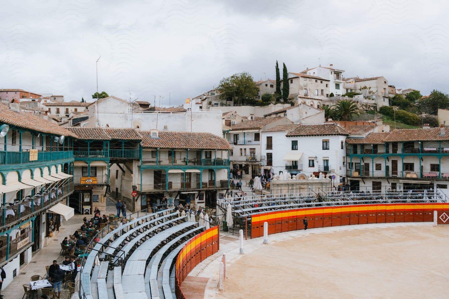 an open field in the middle of a town like a stadium with chairs stand