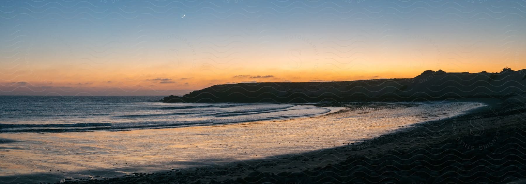 A calm beach at sunset.