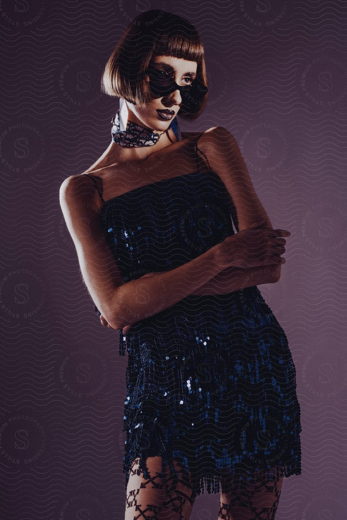 Woman with bob haircut sunglasses and Angelo Tarlazzi Vintage Blue Paillette Sequins Fringe Tube Skirt Set poses for the camera