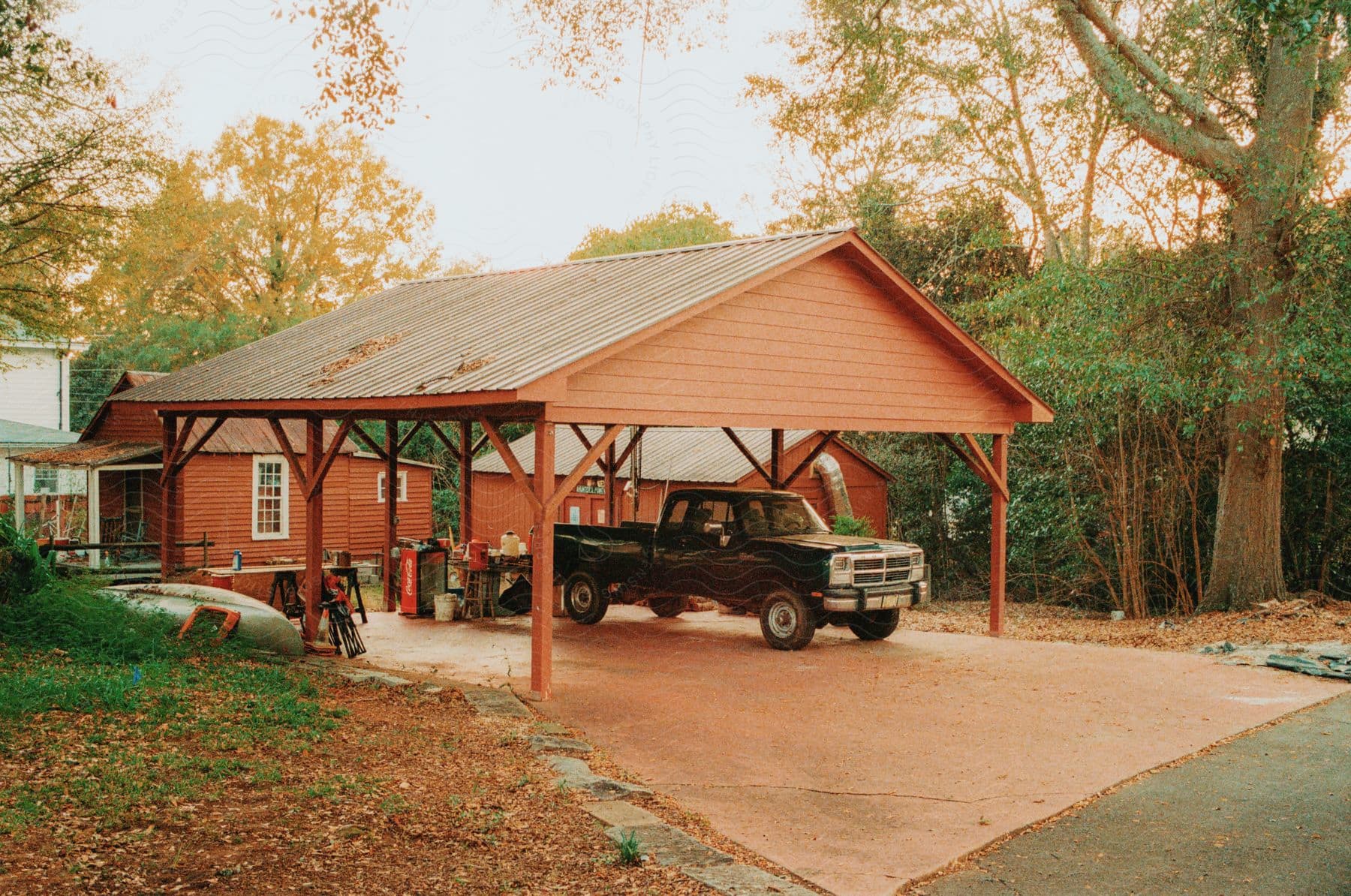 A pickup truck in a covered driveway.