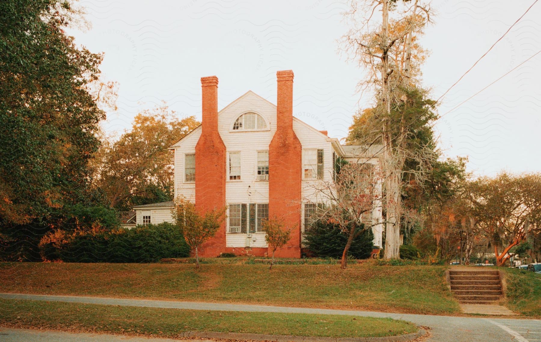 A large suburban house with twin brick chimneys.