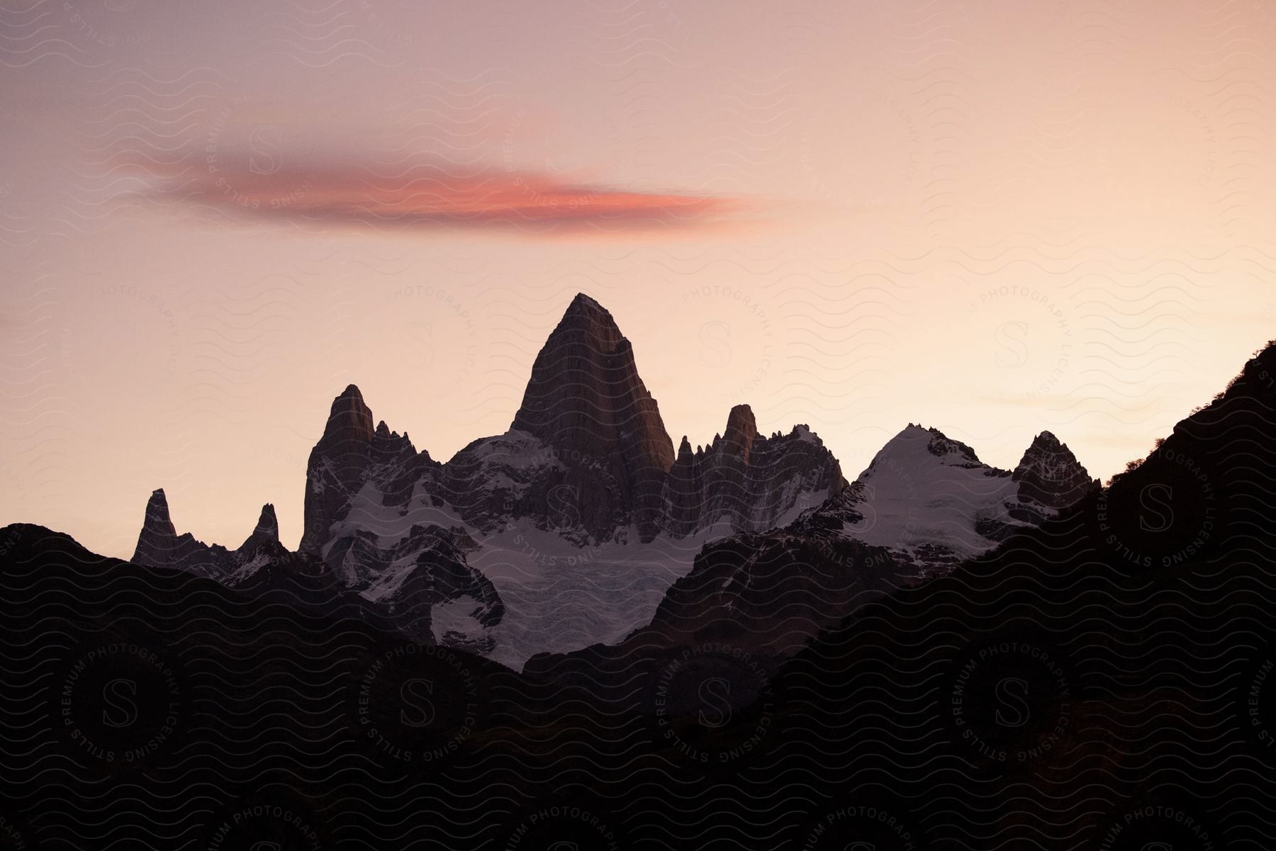 A snowy mountain range with one prominent peak.