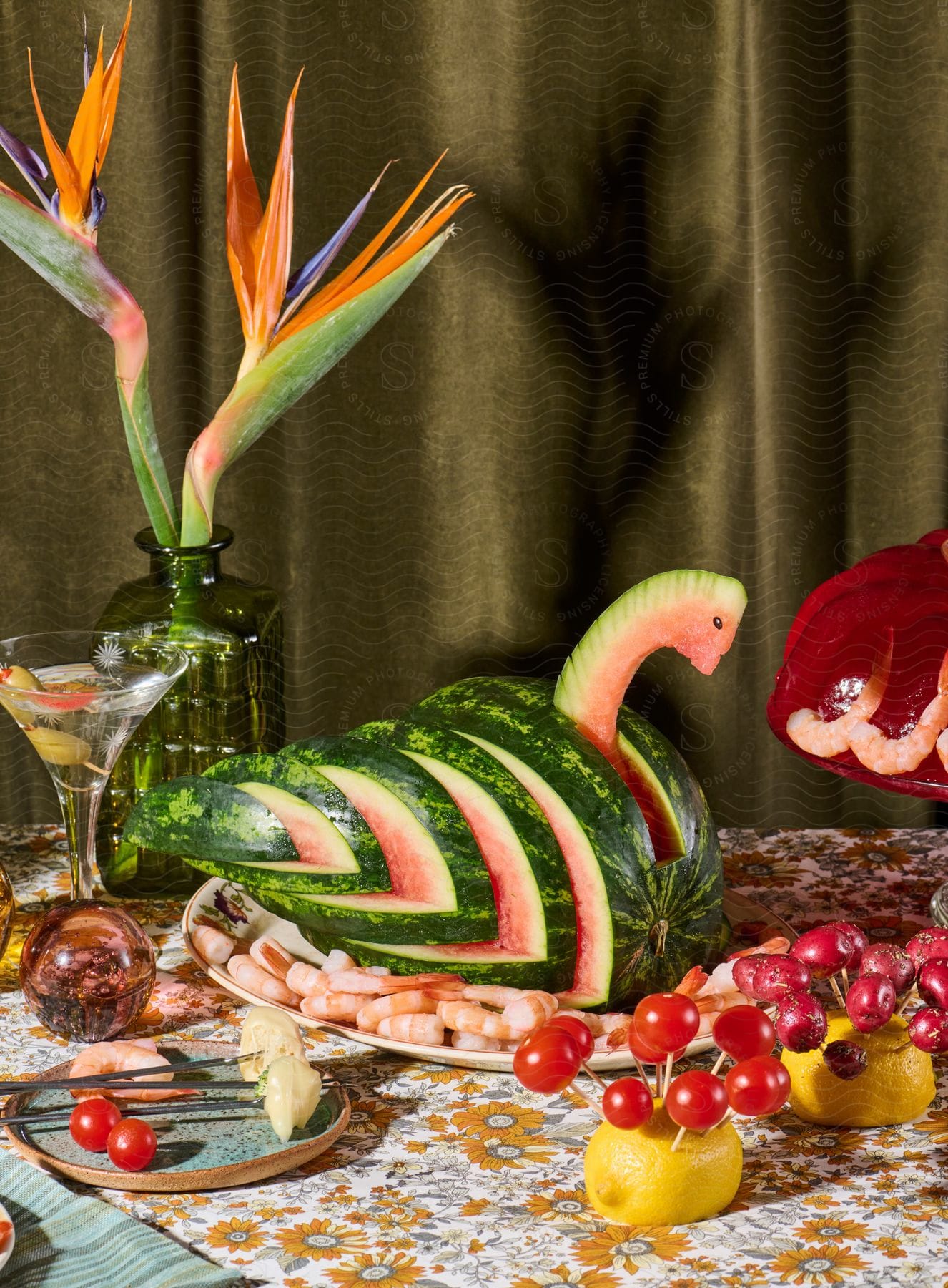 Carefully cut fruit on display and a martini with garnish