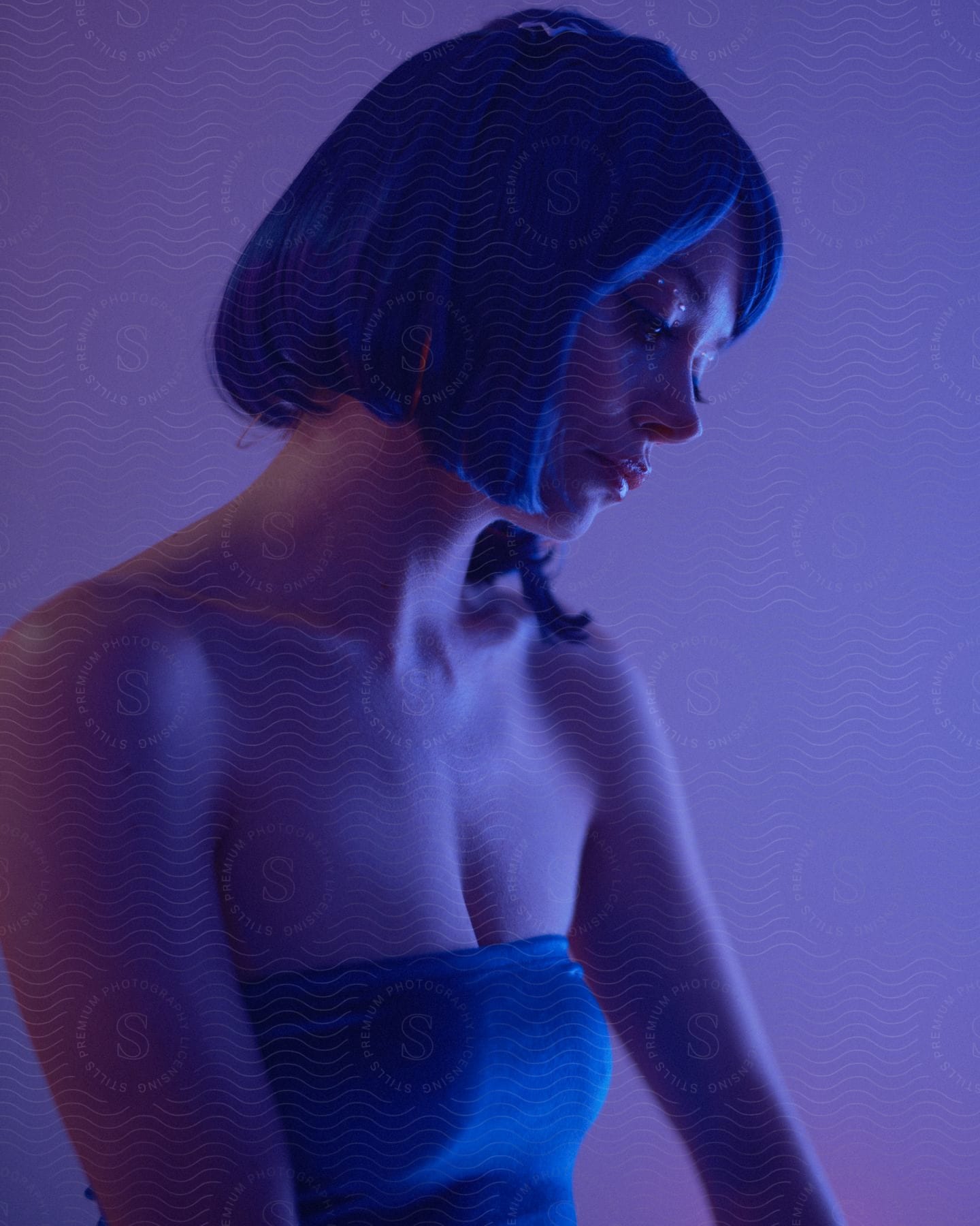 A blue haired woman in a blue tube top.