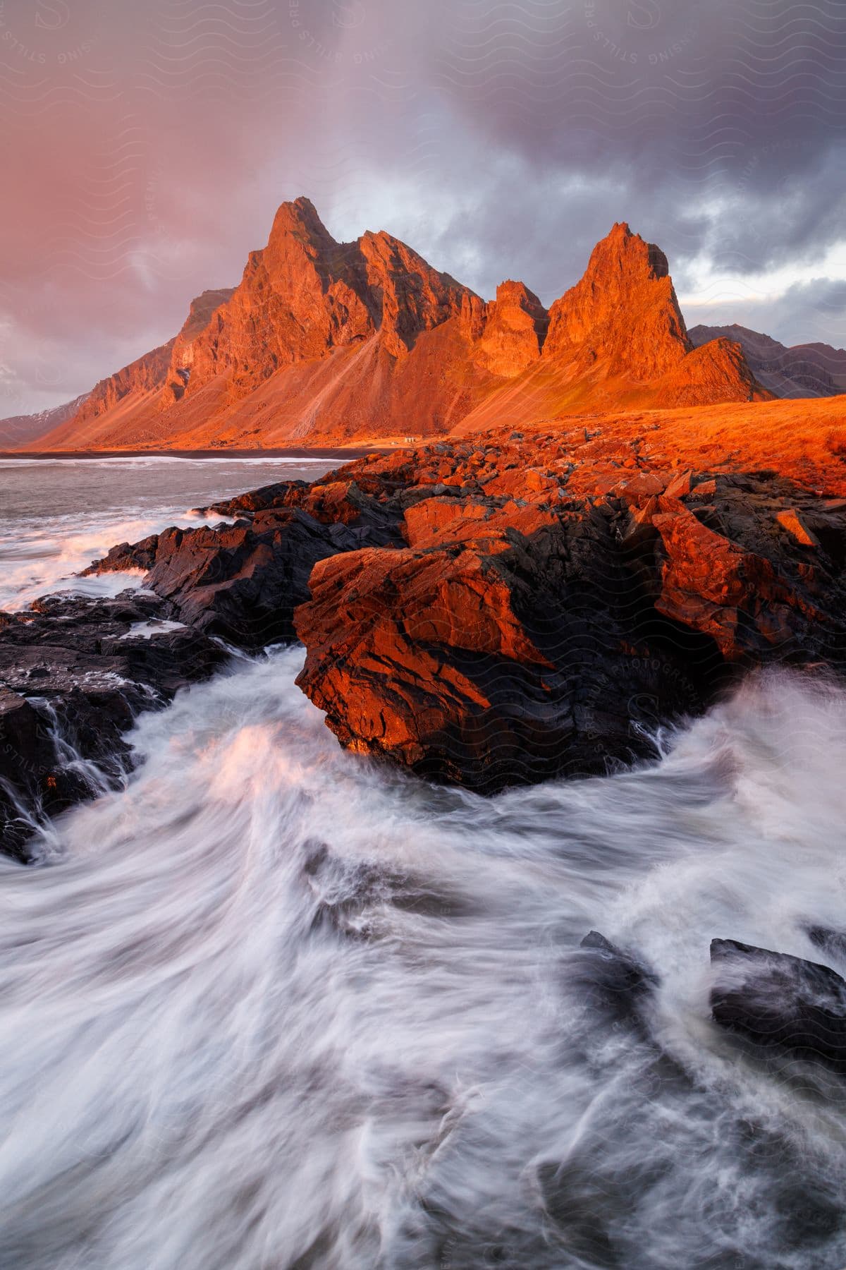 A view of waves crashing against the coast on a sunny day.