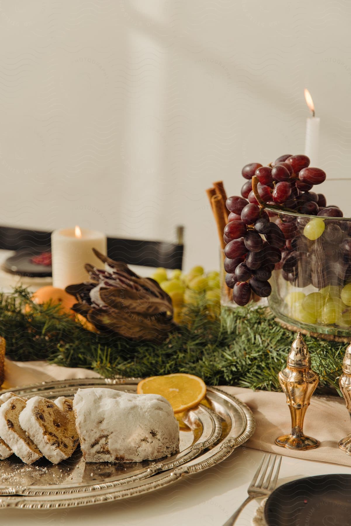 Fruit cake, grapes, and other desserts, on a christmas table.