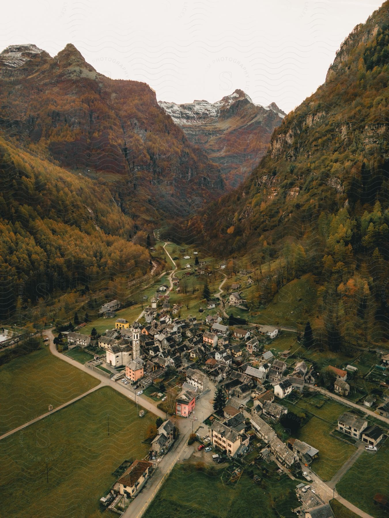 Roads lead to a small village in a forested mountain valley