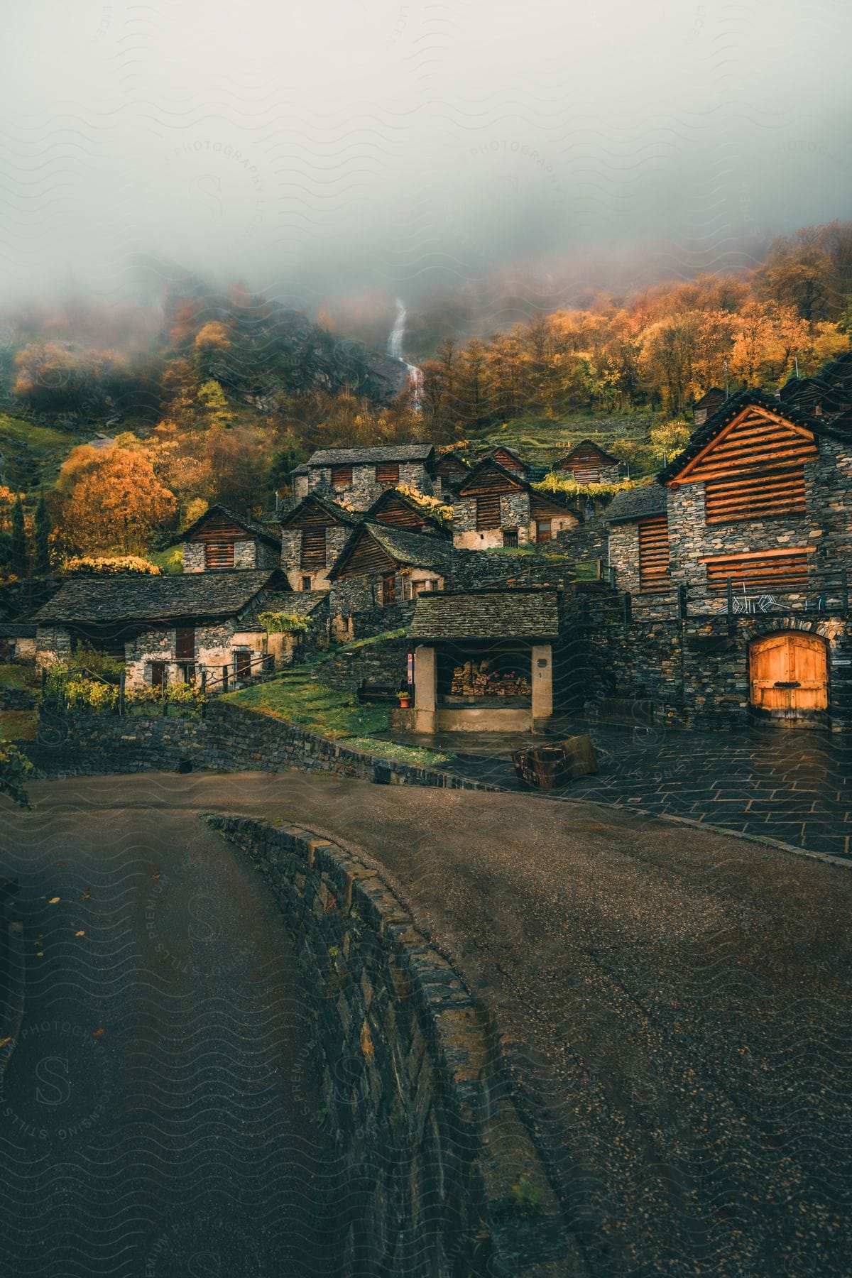 Rural homes up on the side of a mountain during the fall.