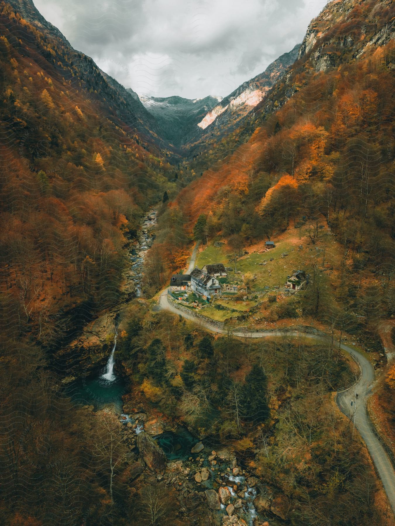 Some small buildings in a rural area in the mountains.