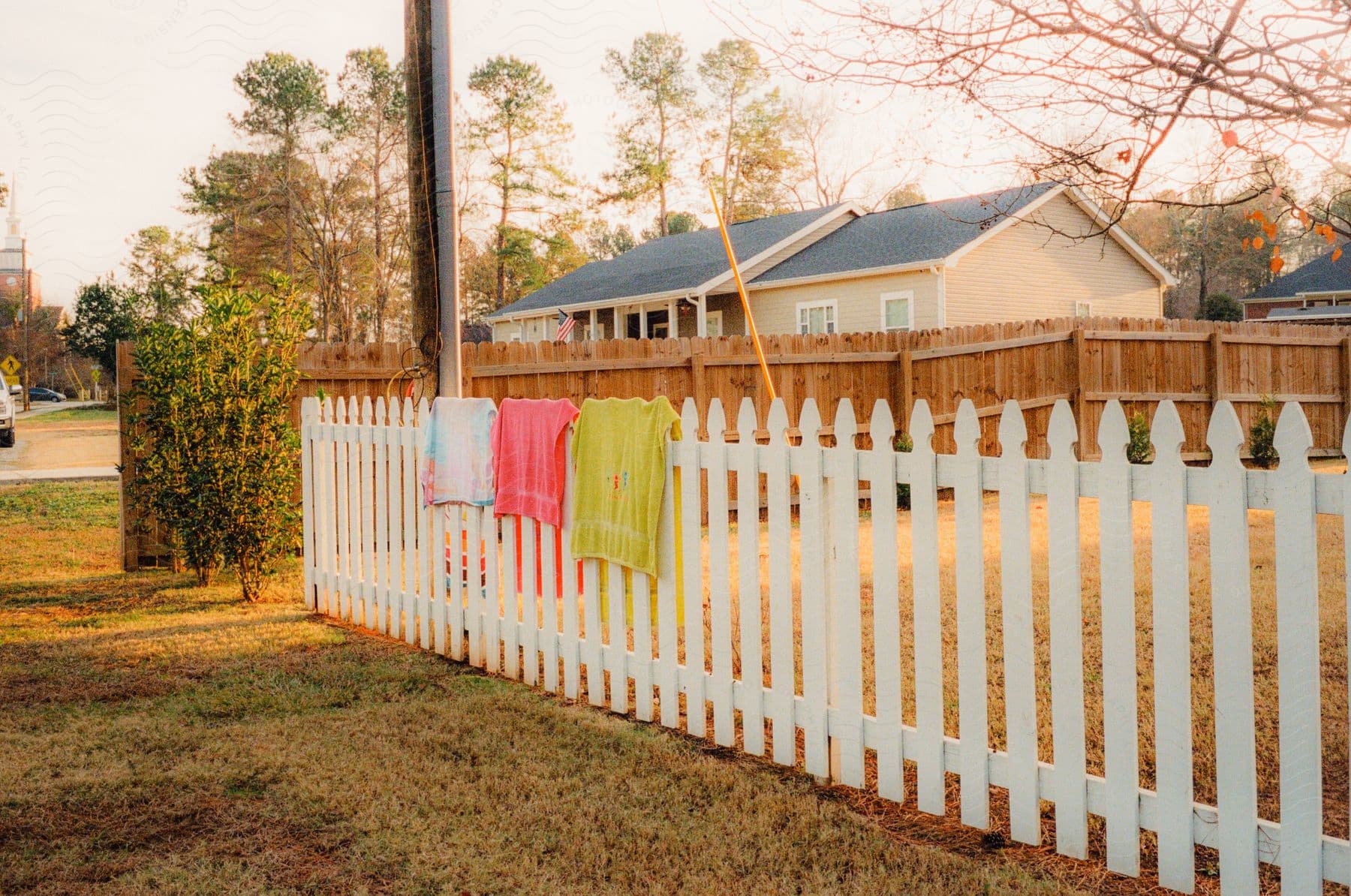 View Of A Wooden Fence With A House Beside It