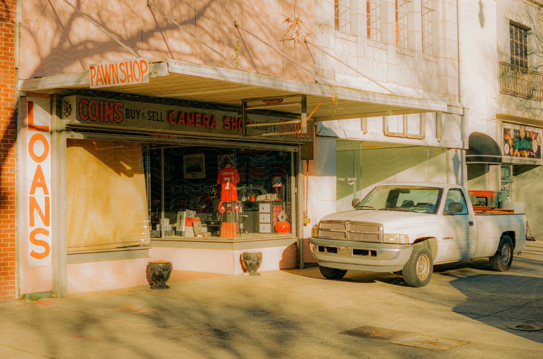 A car stopped outside an establishment on the street