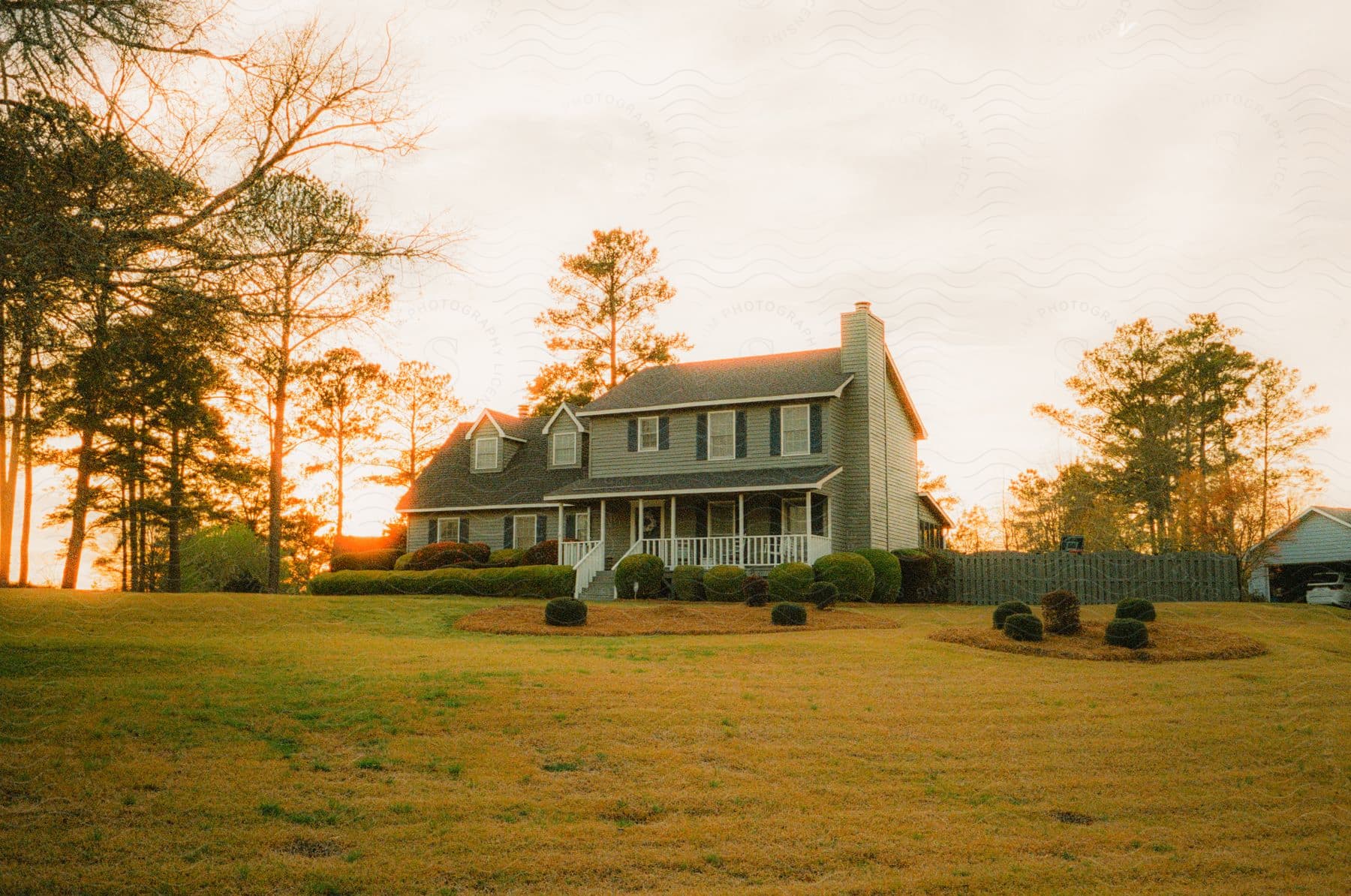 Panorama of a farmhouse in the middle of a field with the dawn sky.