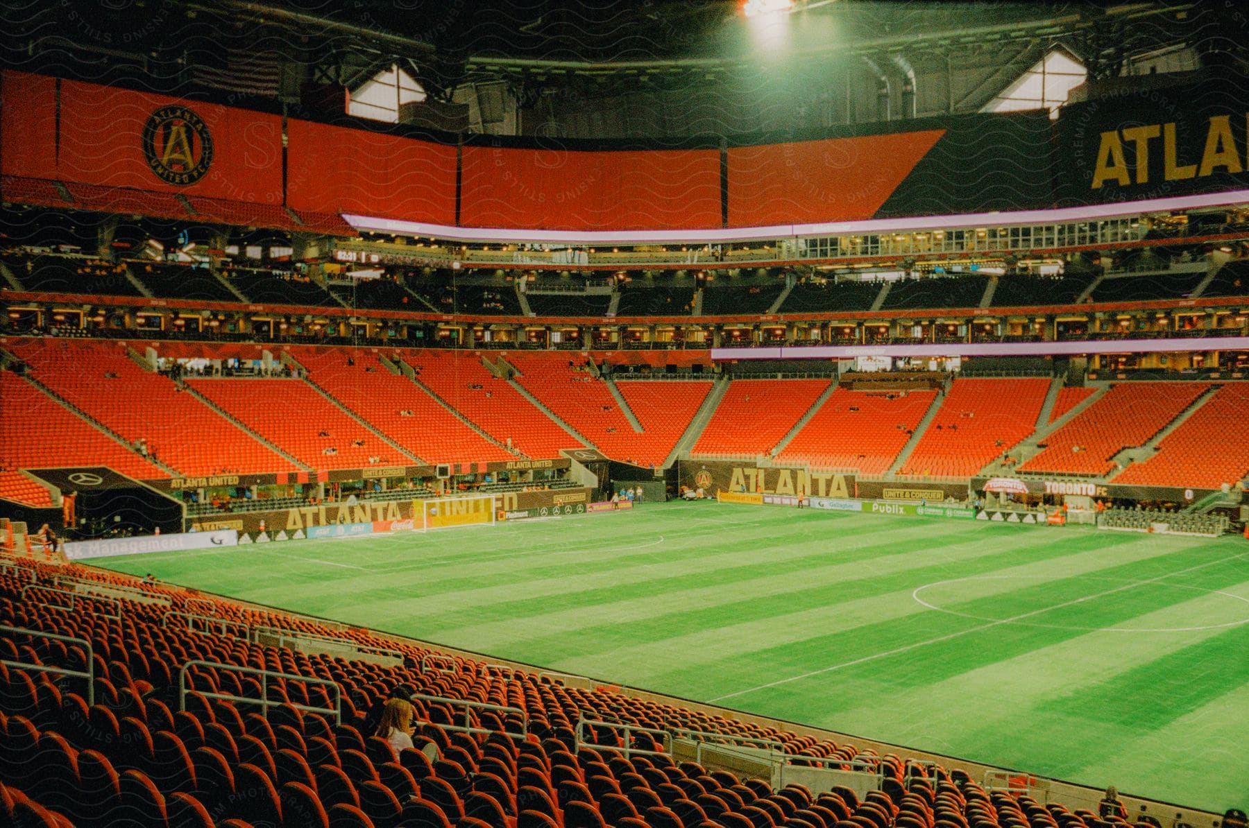 The interior of a football stadium illuminated at night.