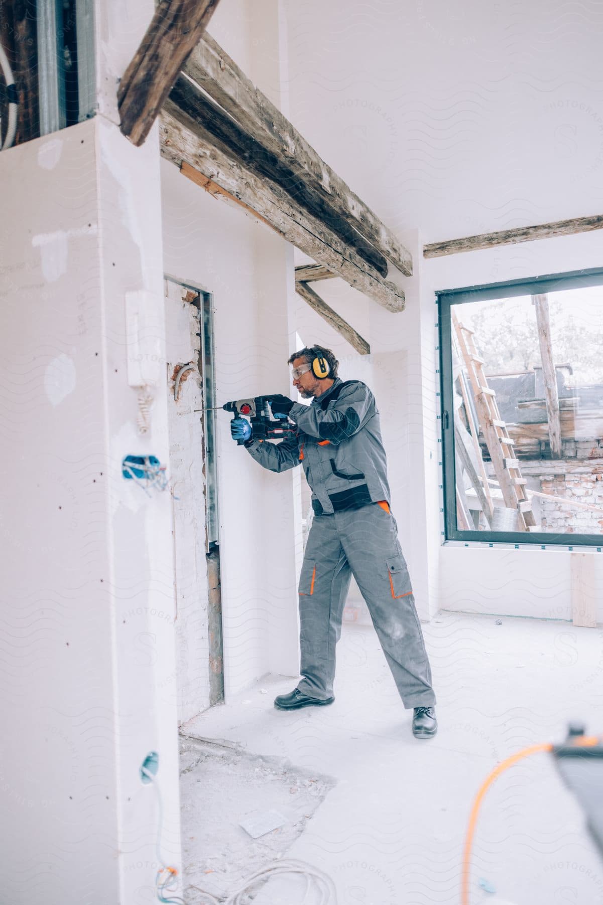 a man drilling into a door in a building project