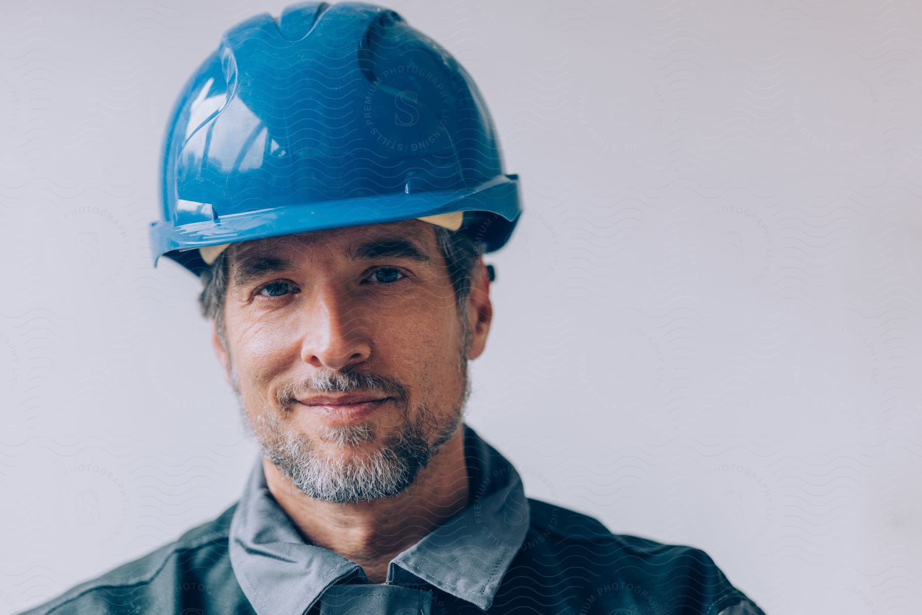 Portrait of a man with a blue protective helmet.
