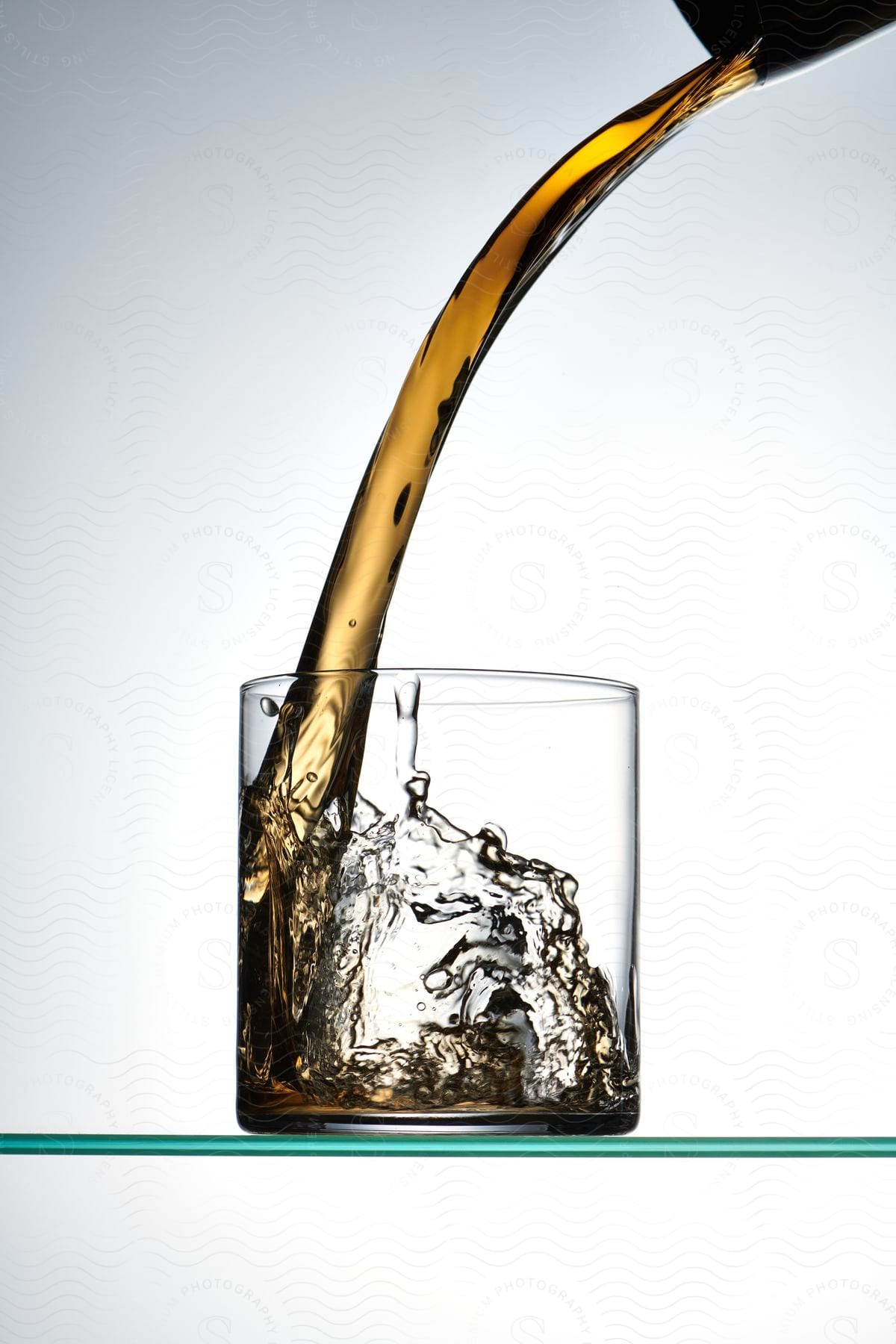 Close-up of a liquid beverage pouring into a glass.