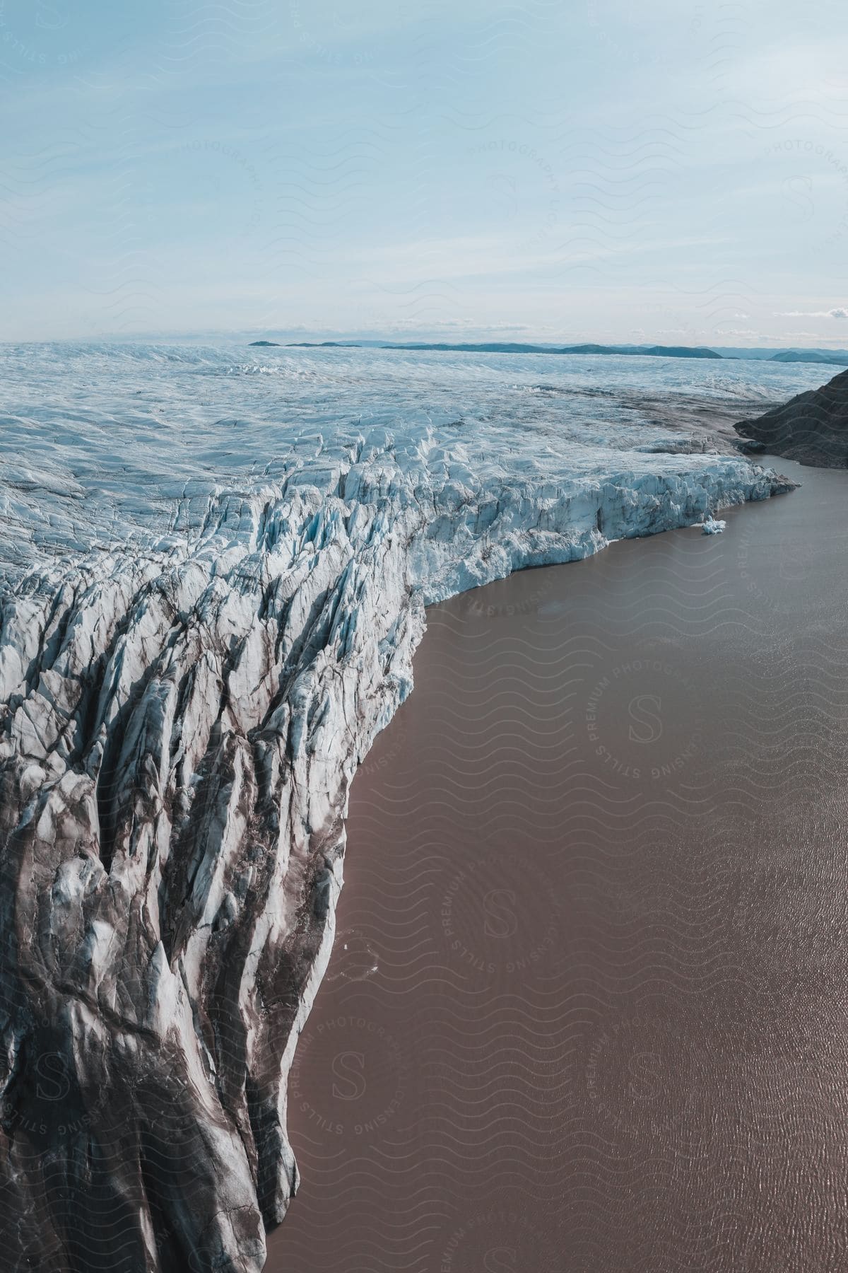 Aerial of ice caps on the coast of a beach.