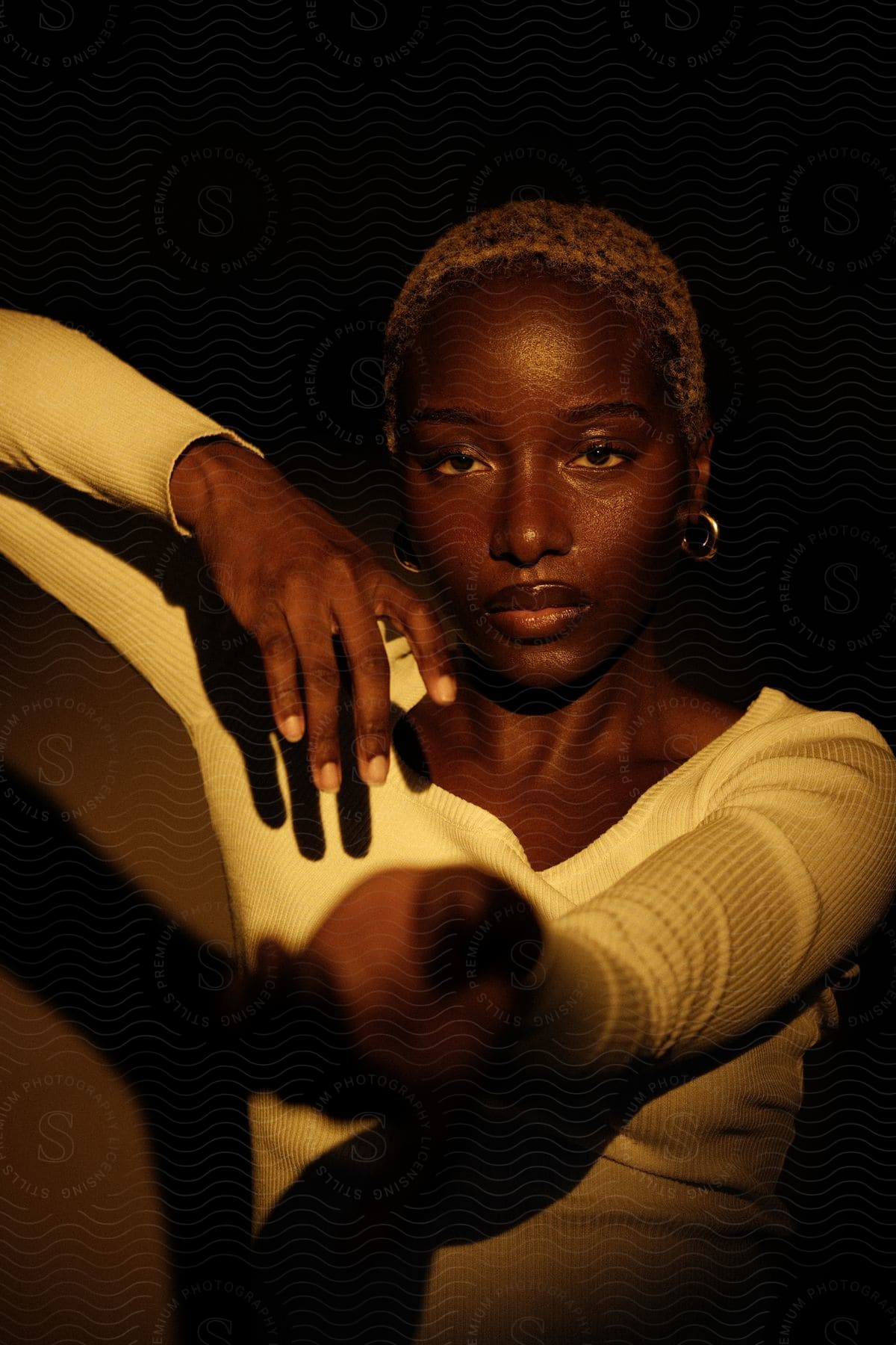 A black woman posed with her arm outstretched palm up offering her hand