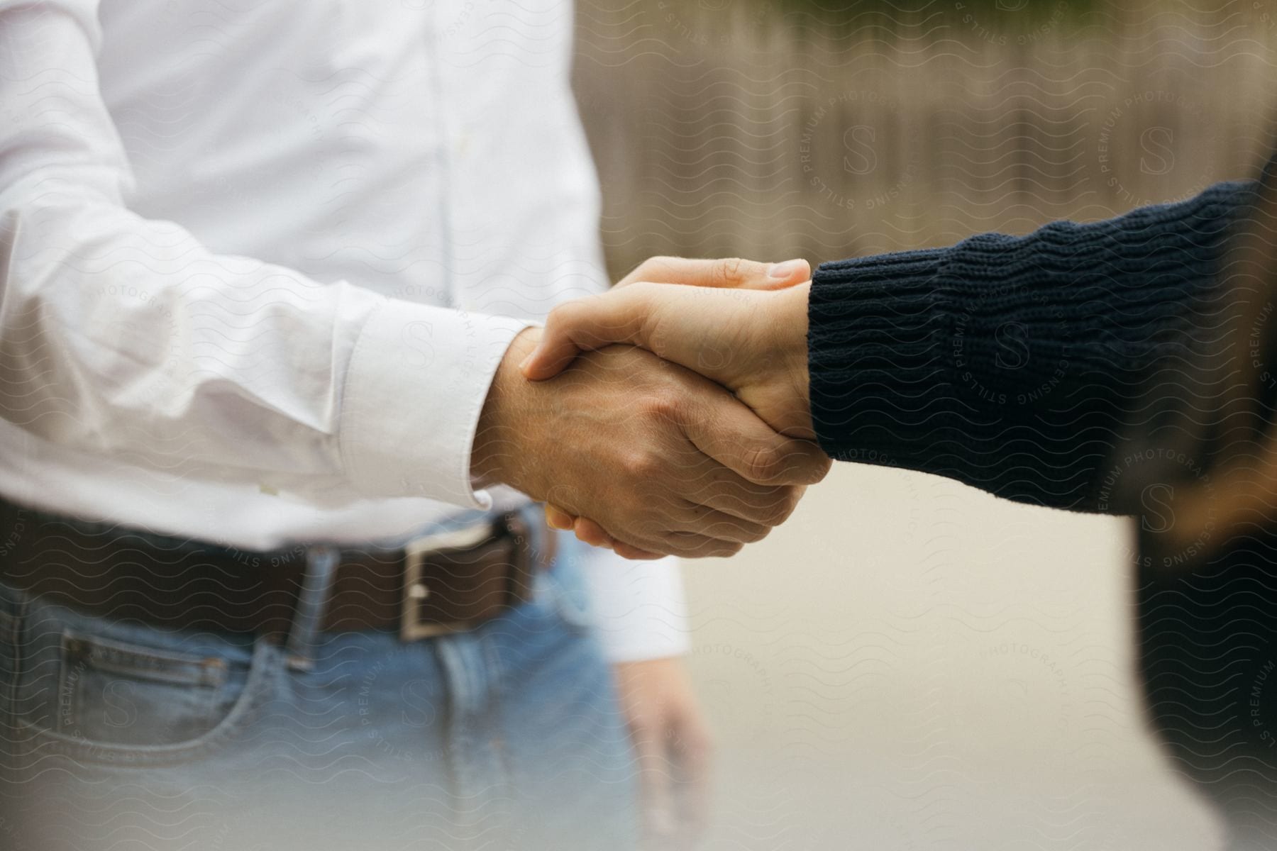 A man shakes hands with another person