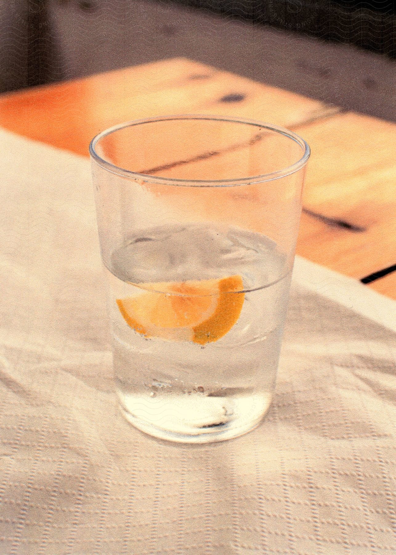 A cocktail sitting on a table outdoors on a sunny day.