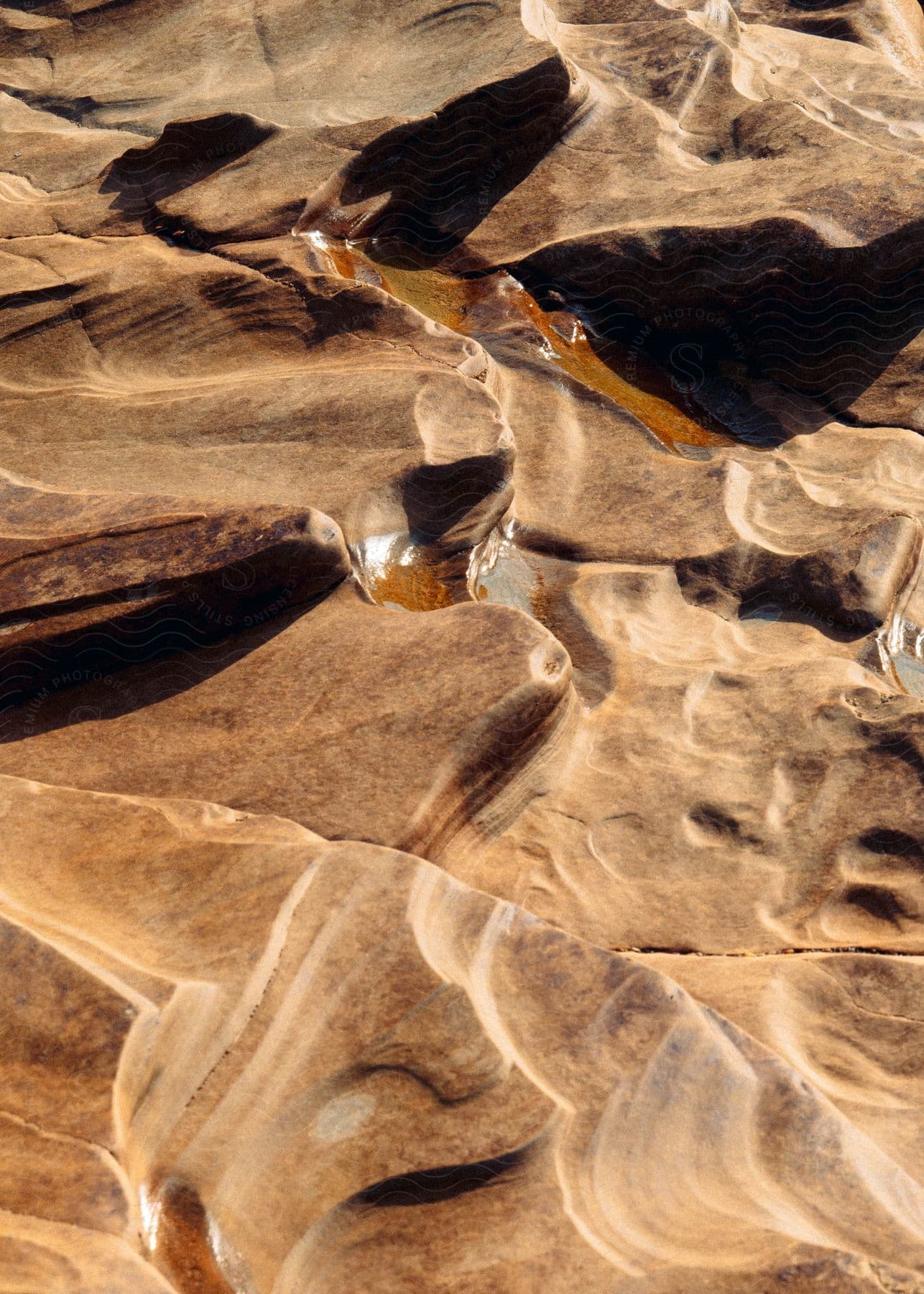 Sunlight shines on rough mountainous desert terrain