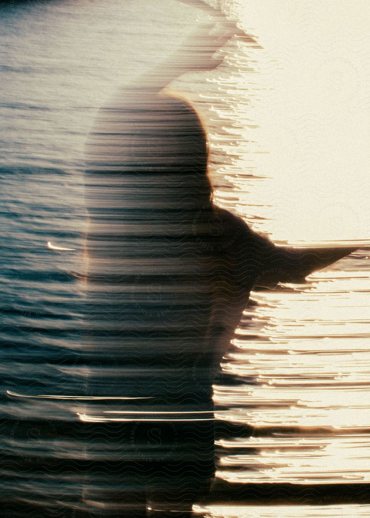 a woman on a river bank with her hands up