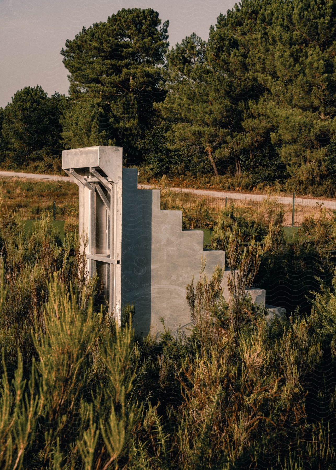 A ruin of a concrete staircase on a lawn