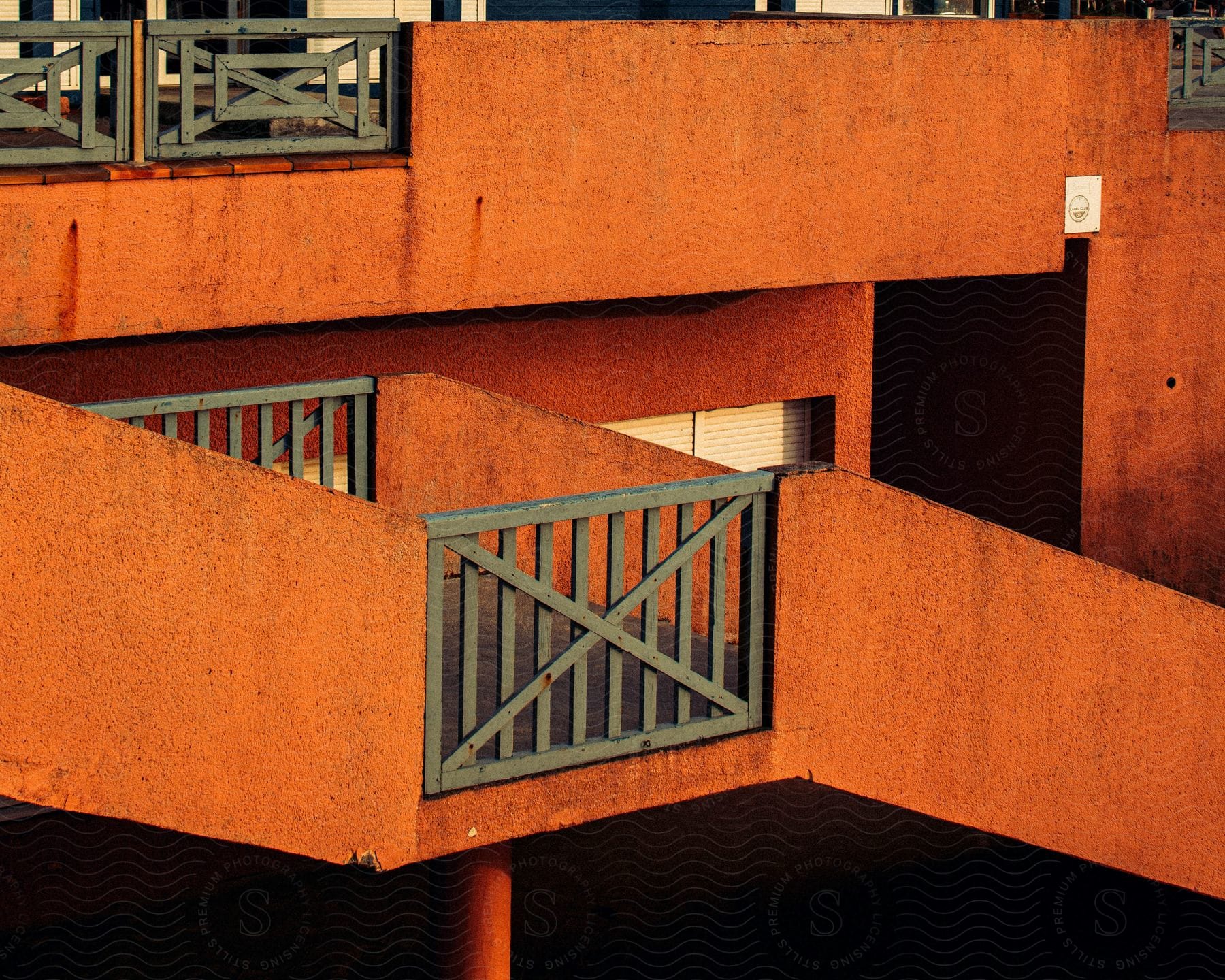 A small wooden door on a walkway that goes up