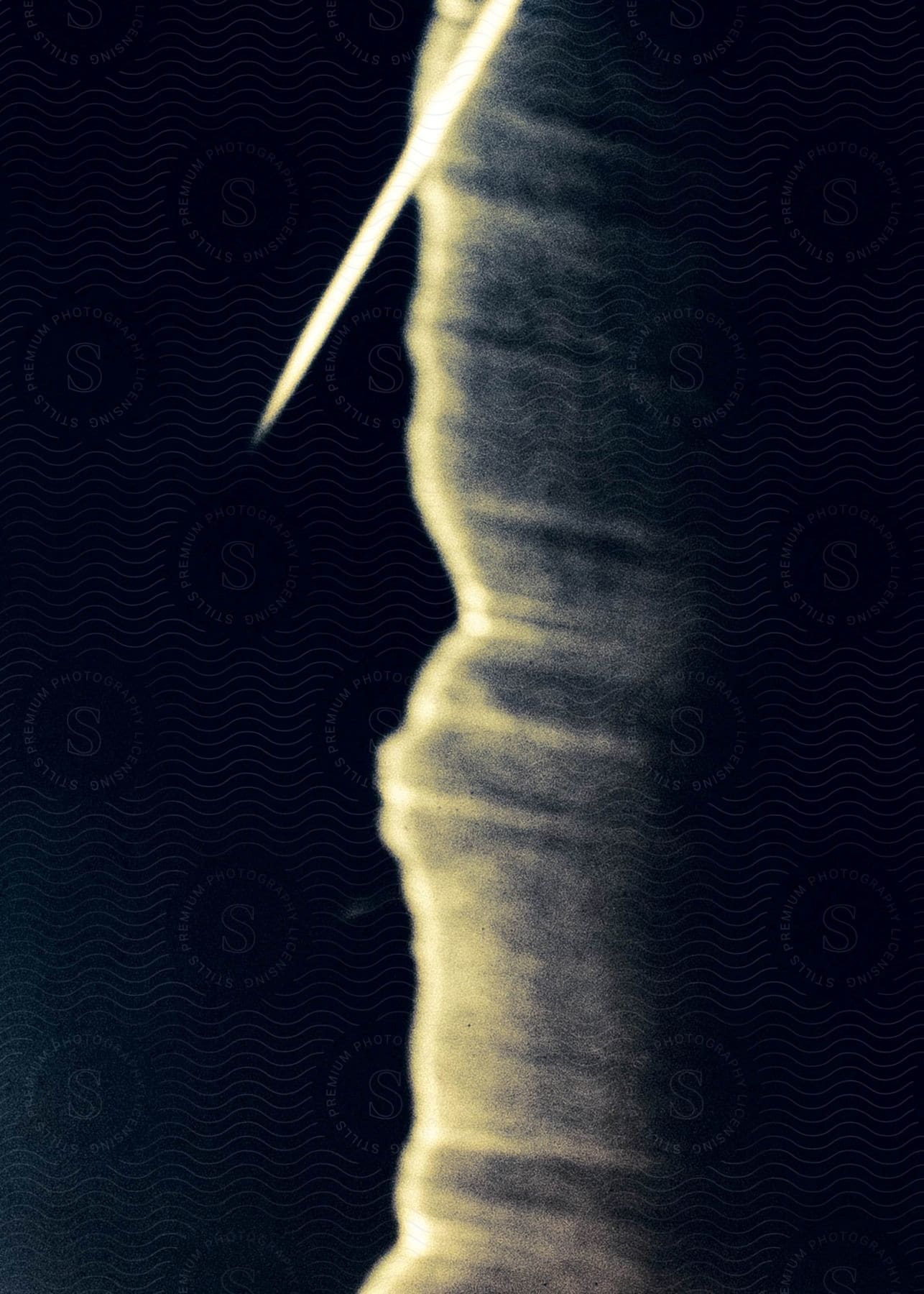 An abstract of a sharp needle or nail against a column