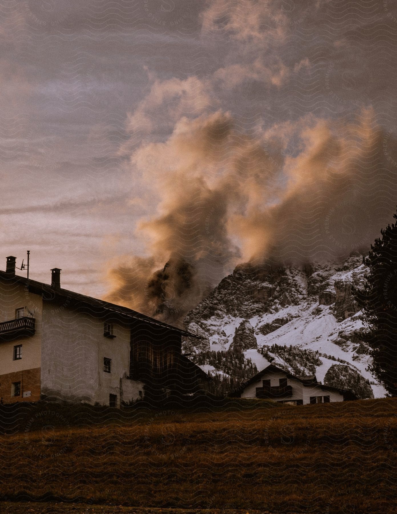 two building in a sub urban region as black smoke covers the sky